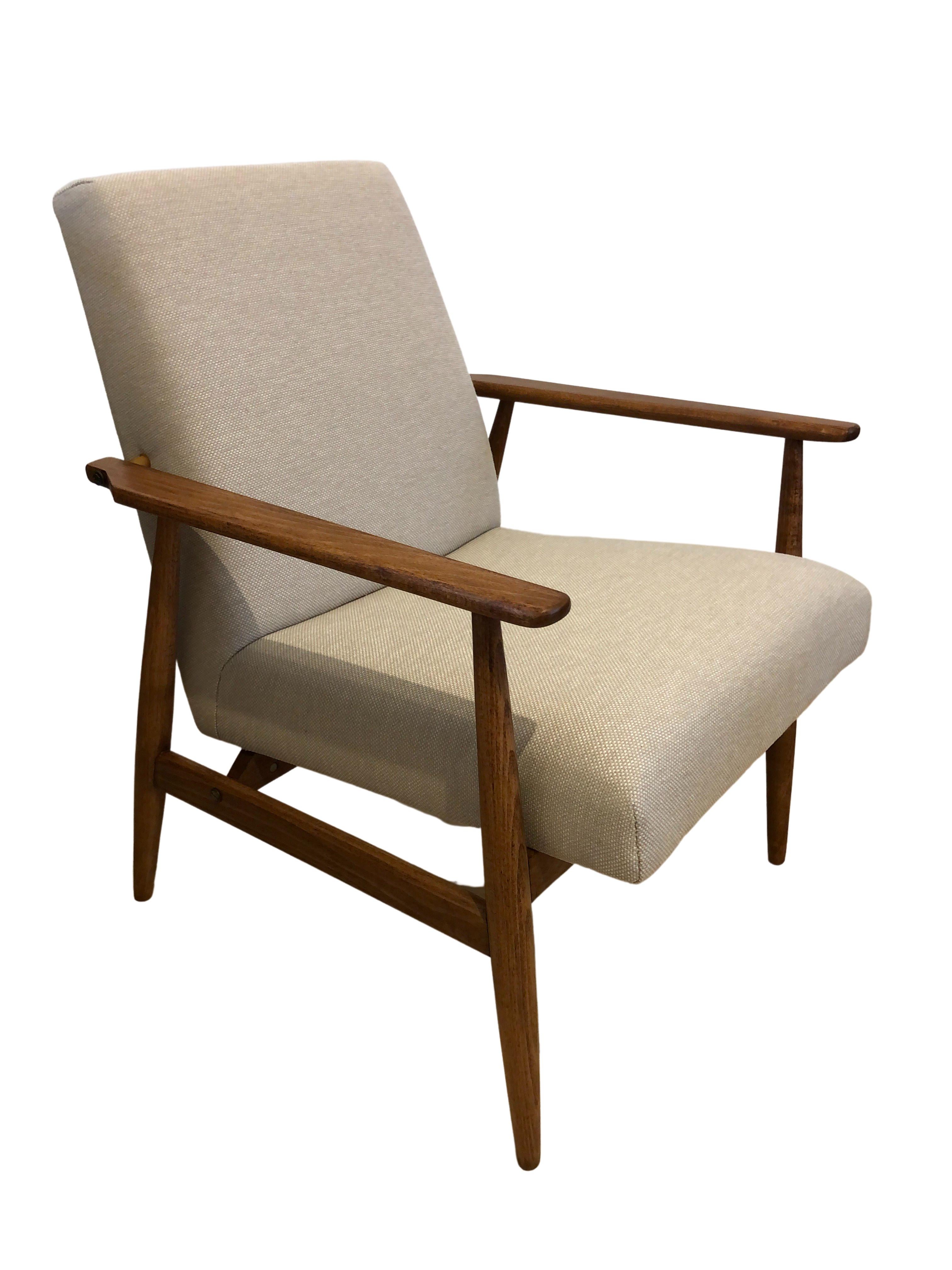 L'ensemble de deux fauteuils conçu par Henryk Lis. La structure est réalisée en bois de hêtre dans une chaude couleur noyer, avec une finition en vernis satiné semi-mat. La tapisserie est un tissu de coton et de lin lourd de couleur beige.