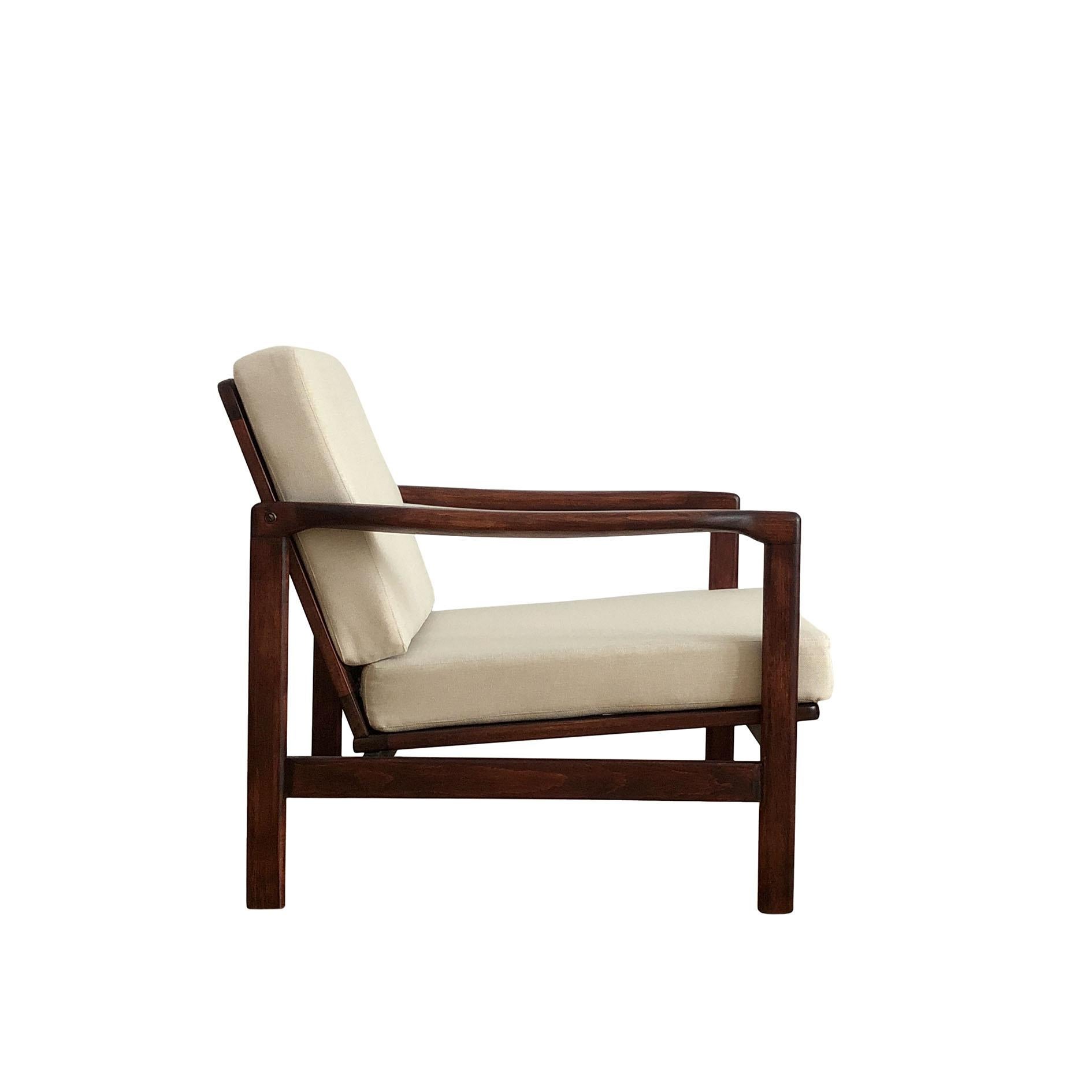 The armchair model B-7752, designed by Zenon Baczyk, has been manufactured by Swarzedzkie Fabryki Mebli in Poland in the 1960s. The structure is made of beech wood in palisander color, finished with a semi matte varnish. The upholstery is high