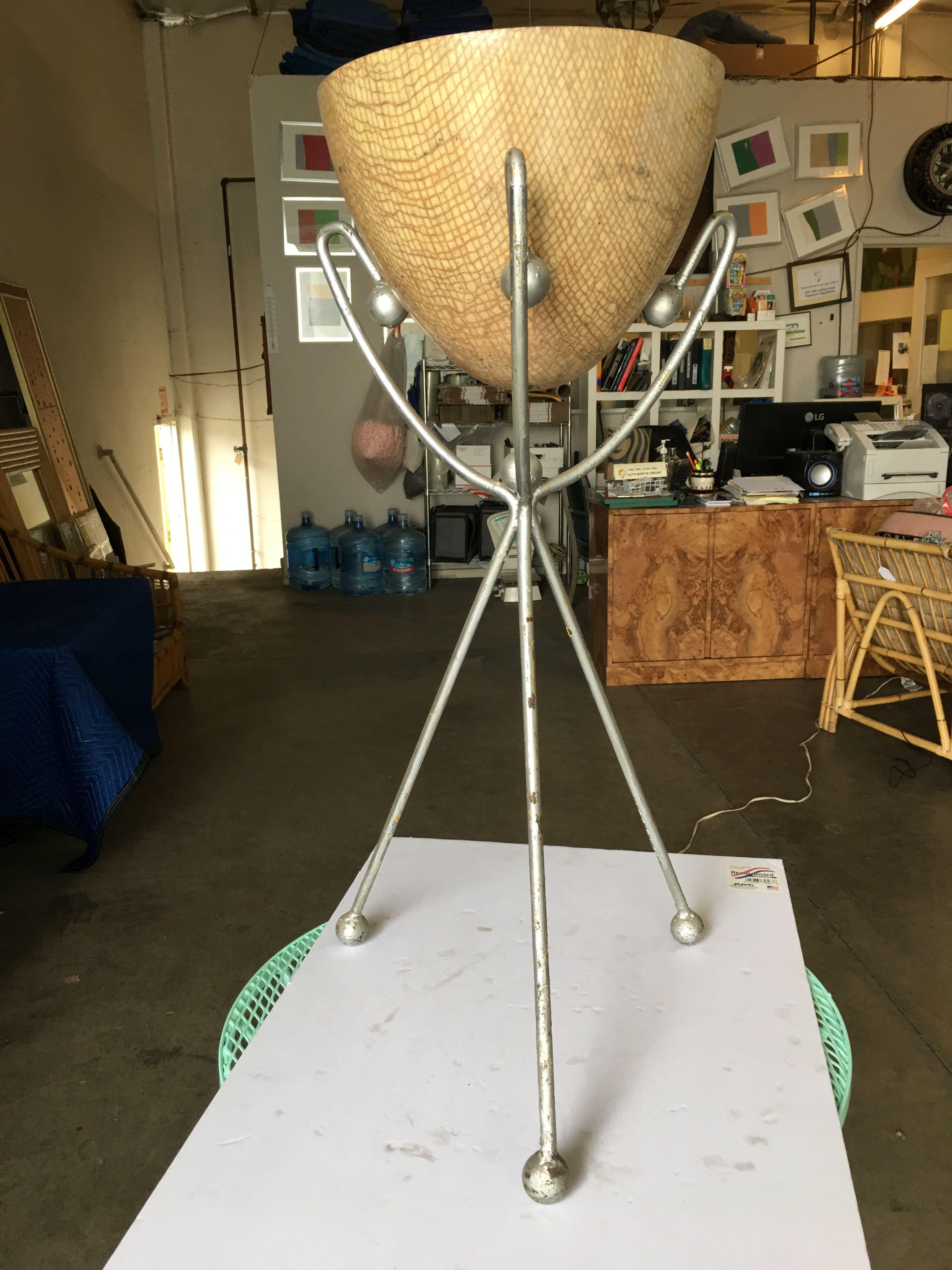 Midcentury beige egg-shaped fiberglass planter with a silver-tone wrought iron wire frame tripod style base.