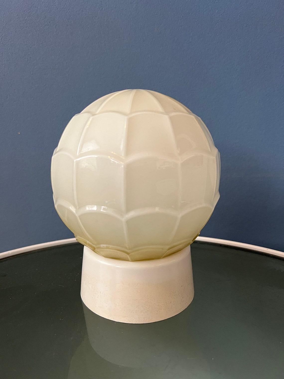 Cute beige thabur opaline glass ceiling lamp. The lamp requires an E14 lightbulb.

Additional information:
Materials: Glass, plastic
Period: 1970s
Dimensions:Height: 19 cm
Diameter: 15 cm
Condition: Very good. The lamp is still looking great, only