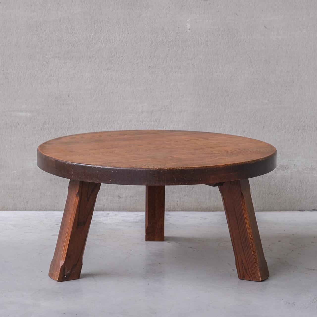 An oak circular coffee table, 

Belgium, circa 1970s. 

Raised over tripod legs. 

Good vintage condition, some scuffs and wear commensurate with age. 

INTERNAL REF: 284/CT0010 

Location: Belgium Gallery. 

Dimensions: 100 Diameter x