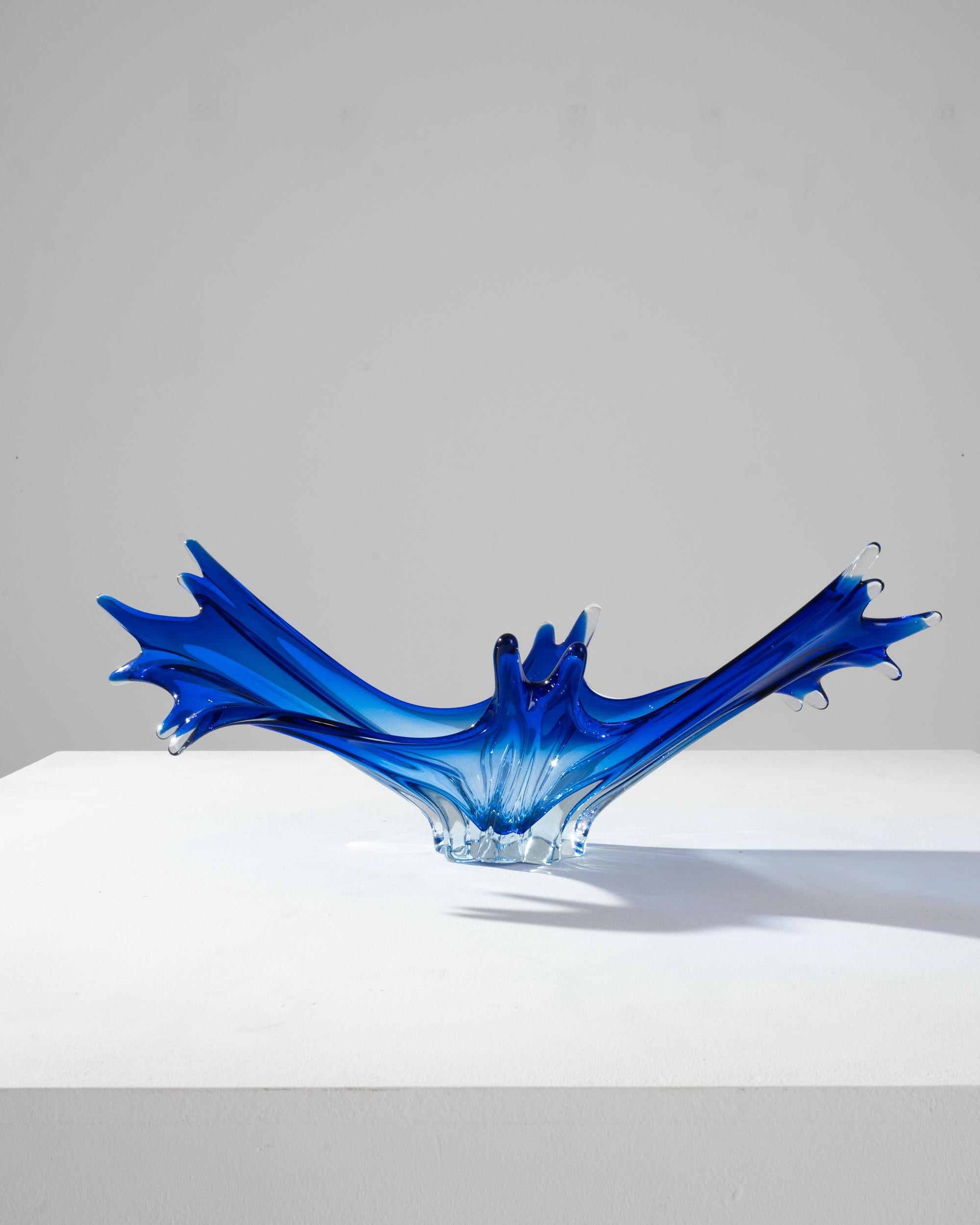 The vivid hues and liquid lines of blown art glass create an unmissable accent. Made in Belgium circa 1960, expressive glasswork forms a bold silhouette. Organic and abstract, reminiscent of a water droplet captured in slow motion. A luminous