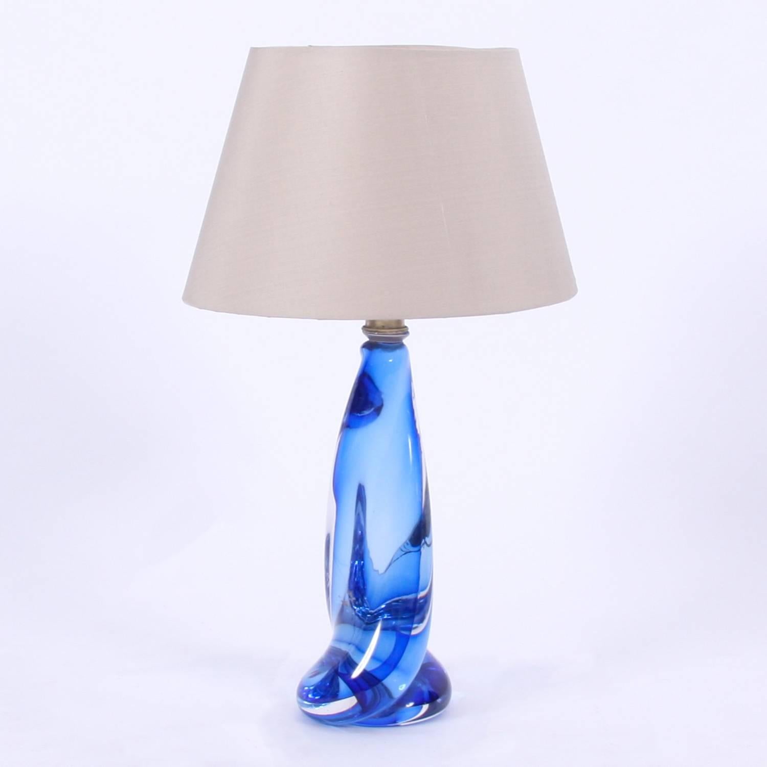 Belgian, circa 1960

A rare pair of Val Saint Lambert table lamps with twisted blue glass. 

Pictured with bespoke, handmade, silk shades. Rewired and PAT tested.