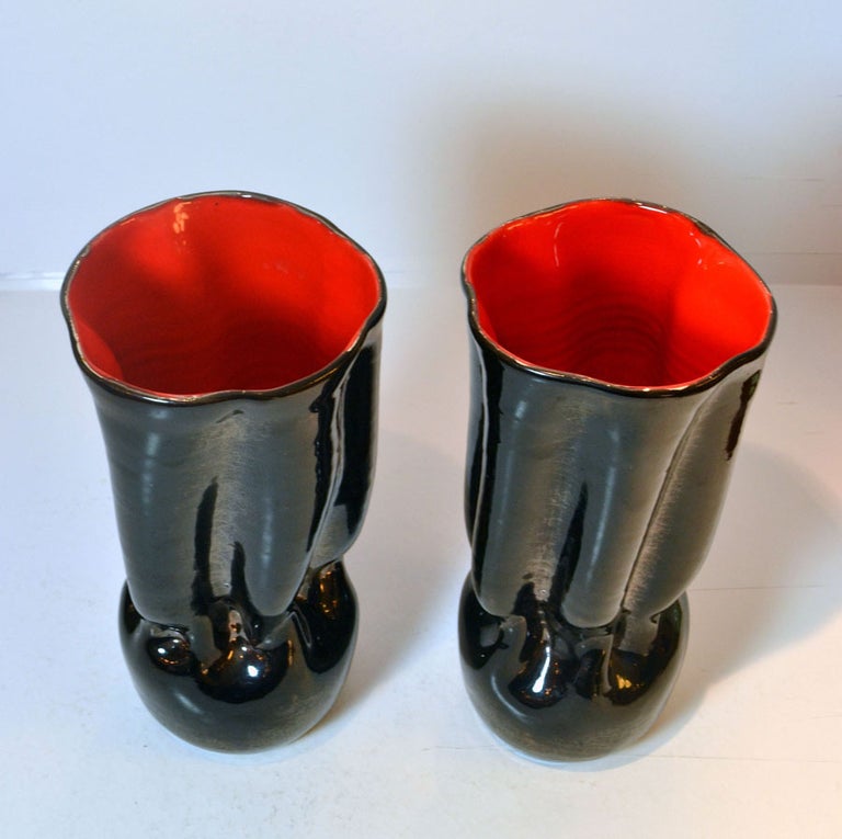 Black ceramic vases are turned and hand formed, the shiny glaze is black outside and lipstick red inside signed by Céramique de Louvière DK, Belgium, 1950s. They are very decorative and in excellent condition.
