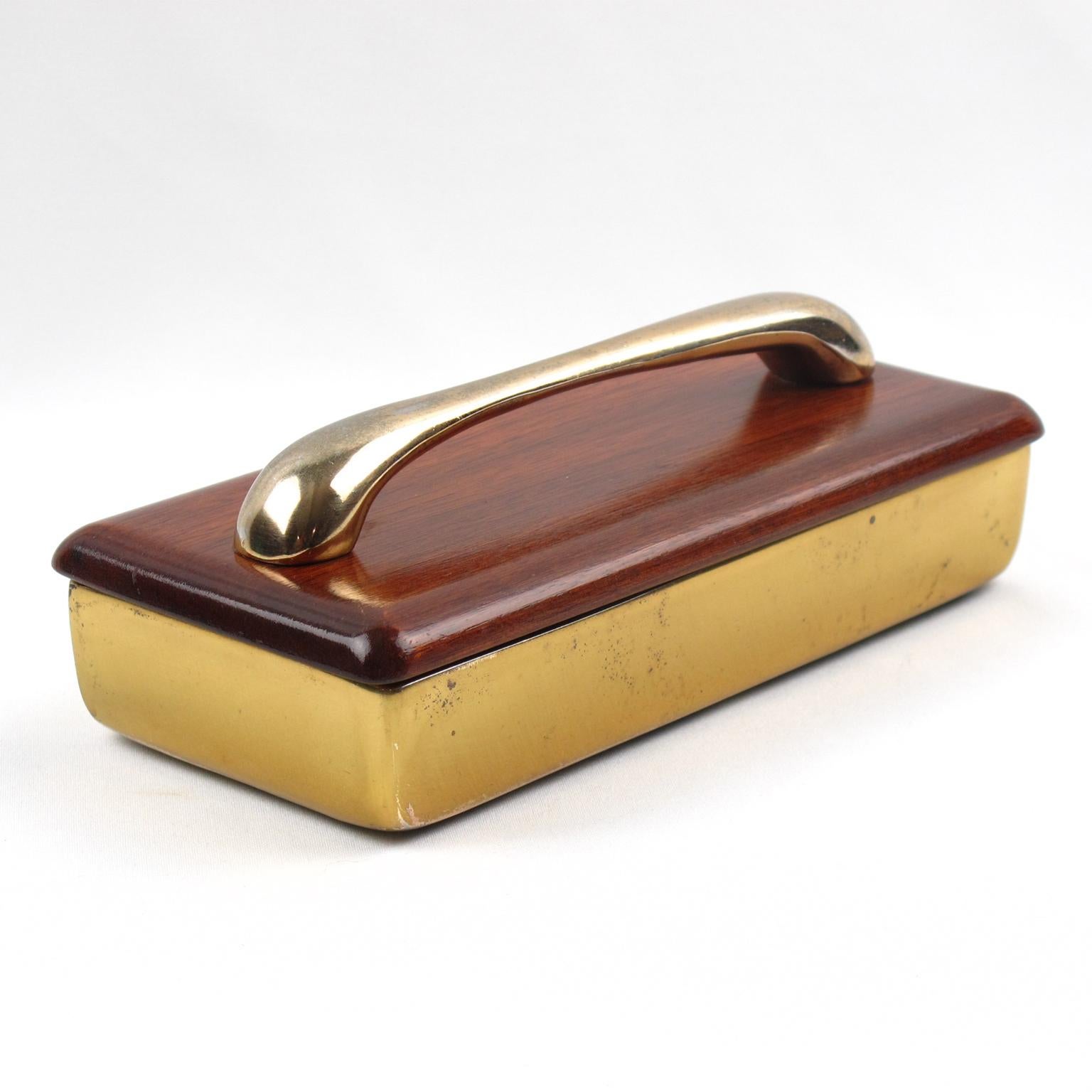 Beautiful Mid-Century Modern brass and rosewood decorative lidded box by Ben Seibel for Jenfredware. Heavy gilded brass rectangular box, partitioned with the original cork lined interior. Thick rosewood lid with heavy gilded brass handle. Fully