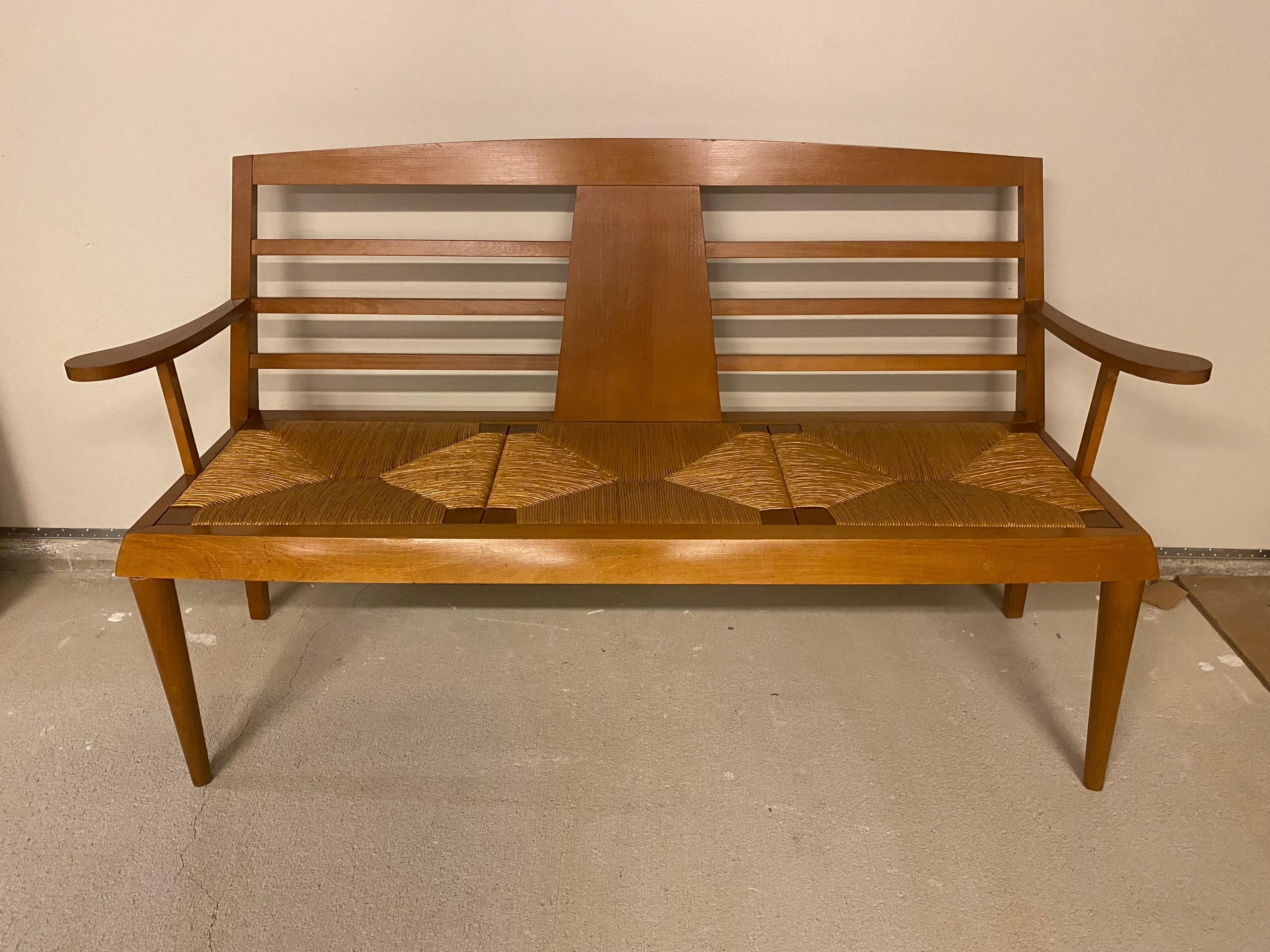 Mid-century modern armed wood bench with back and three woven rush seats, France, 1950's.