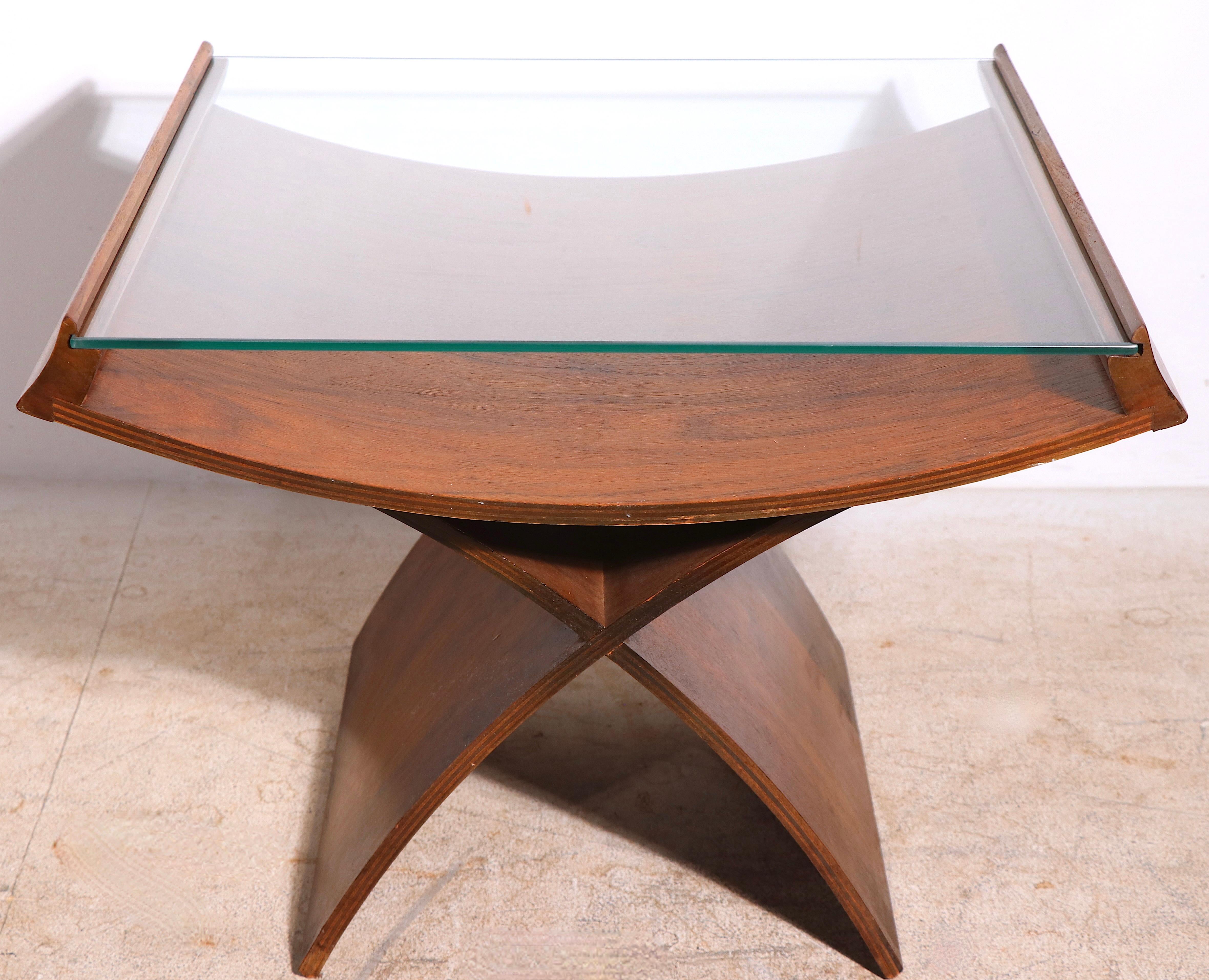 Chic mid-century side, or end, table having an arched bent wood base and center with slide in plate glass top. Sophisticated architectural Japanese influenced design, probably American made, unsigned. 
The table is in very good original condition