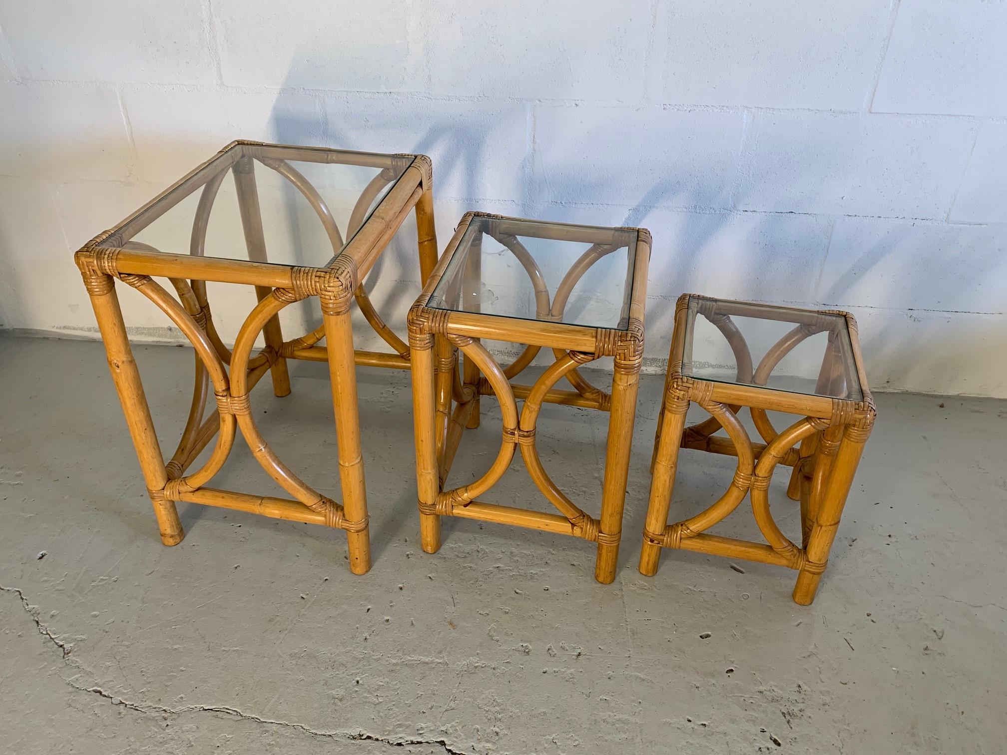 Rattan triple nesting tables feature bentwood rattan in the manner of Paul Frankl. We have two identical sets, price is per set. Glass tops on each table. Very good condition with minor imperfections consistent with age.

NOTE: Only one set of