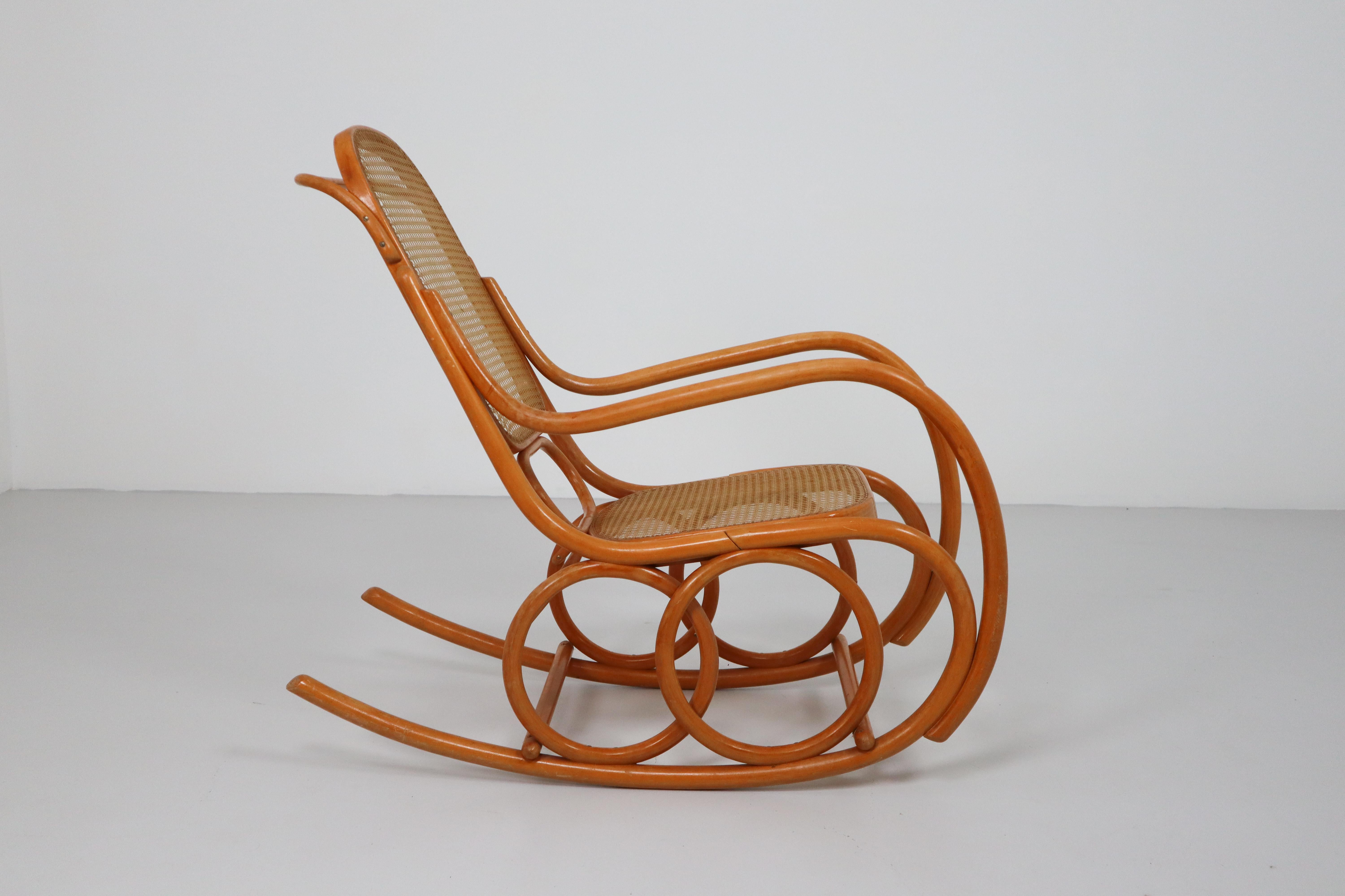 Midcentury rocking chair made of blond beech bentwood and cane. This rare rocking chair was made in the 1950s. Great curves and good original condition.