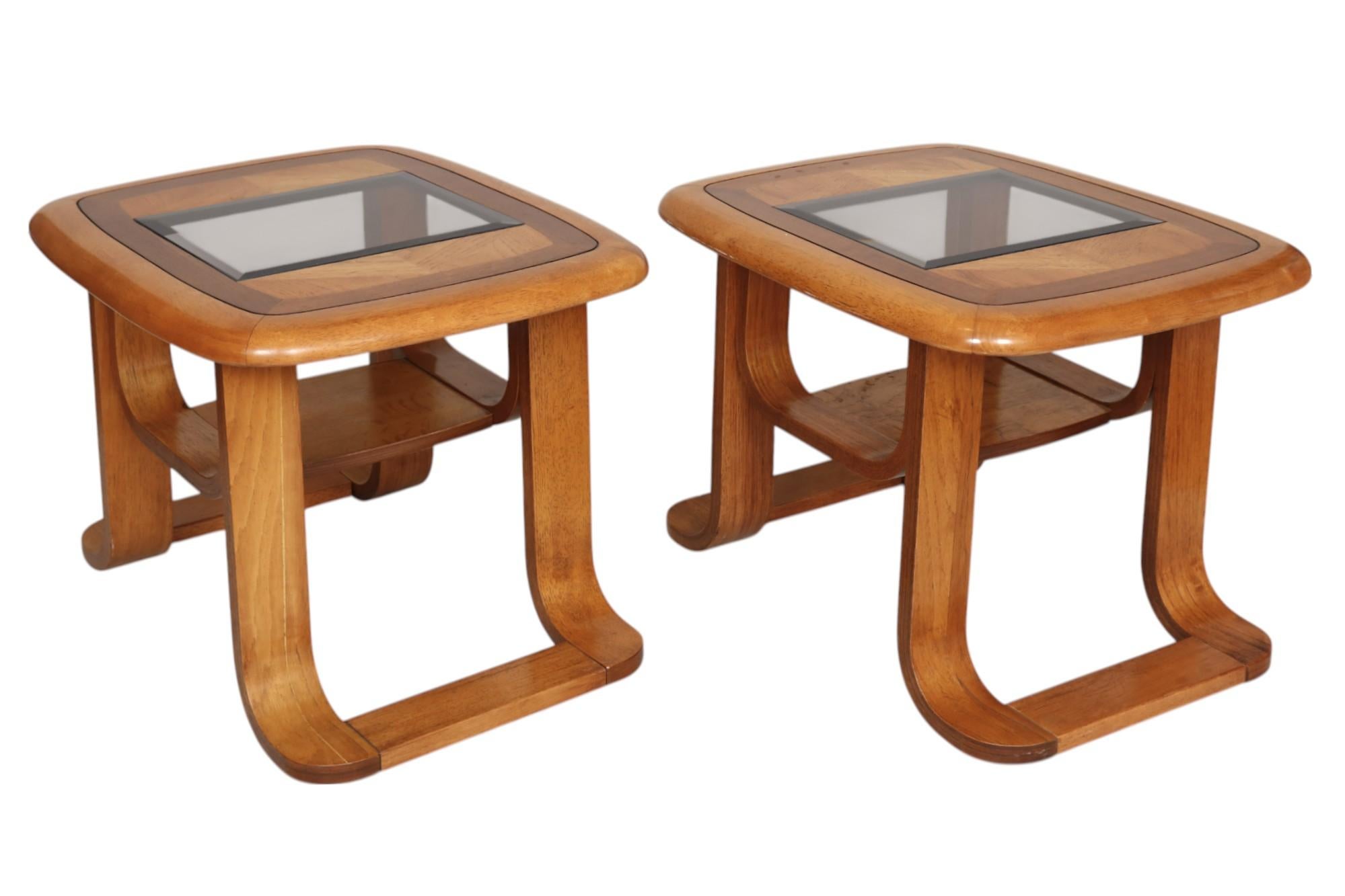 A pair of mid-century bentwood glass top side tables. Rectangular tables are made of maple, decorated on top with triangular panels, banded rounded edges with beveled details, and inset with beveled smoked glass. Bentwood legs are turned outwards in