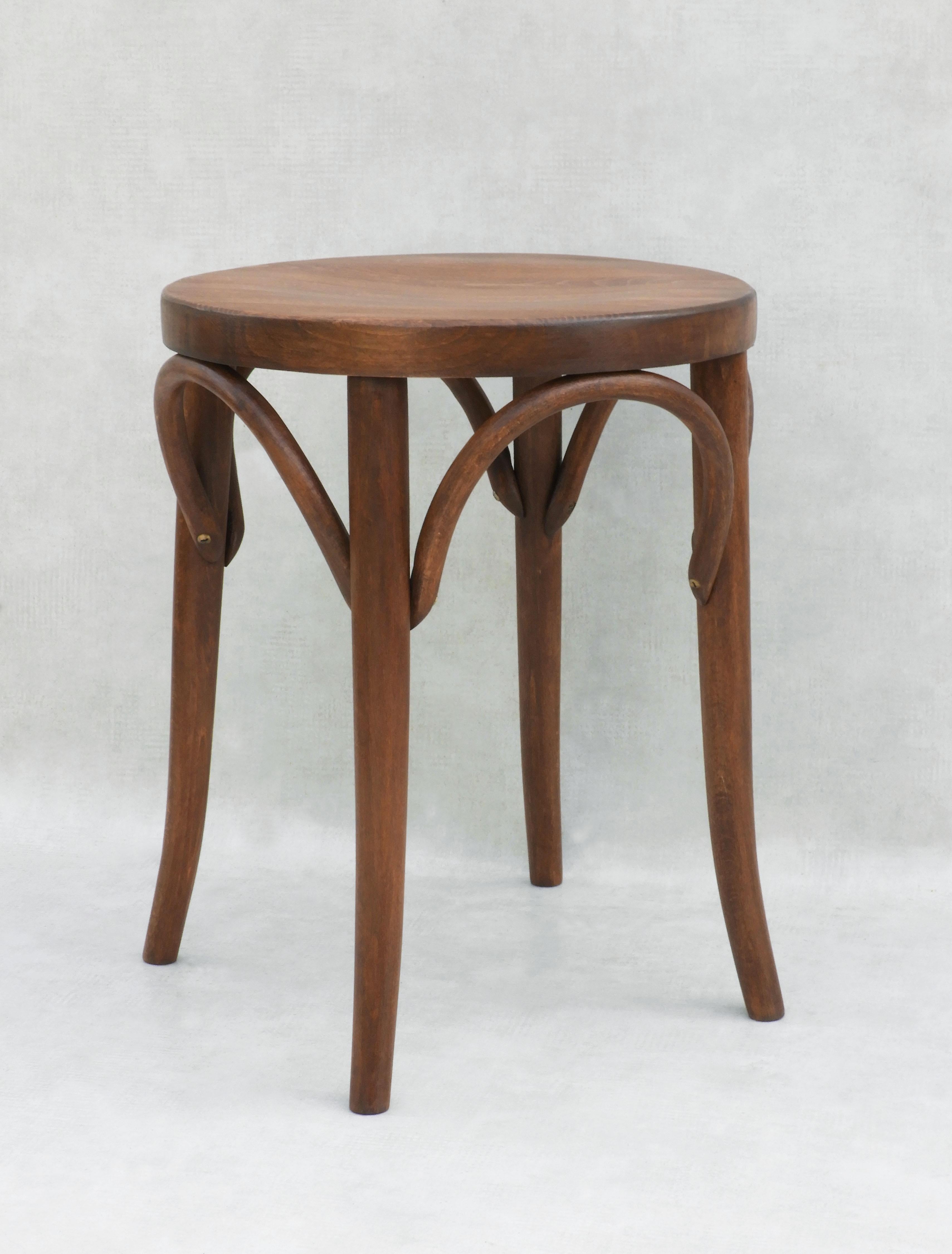 A mid-century bentwood stool with a solid wooden seat, in the style of Thonet, C1950s France.  Well-made round tabouret stool, sturdy and sound with good colour, grain, nice patina and in great vintage condition.  The more unusual solid wood top has