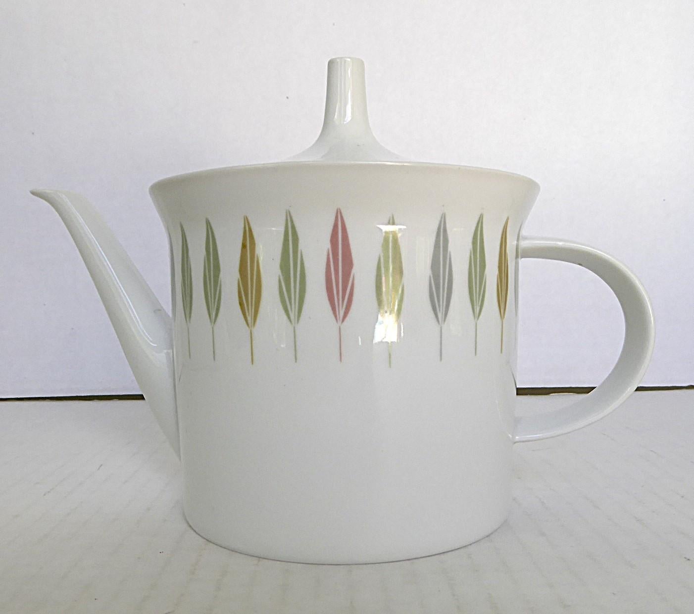 From 1959 Tea Pot by Rosenthal Germany with pattern named after the famous Tiergarten in Berlin. Slick designed form and simple decoration.  Under the flared rim, a band of stilized leaves in alternating gray, green and pink on a white porcelain