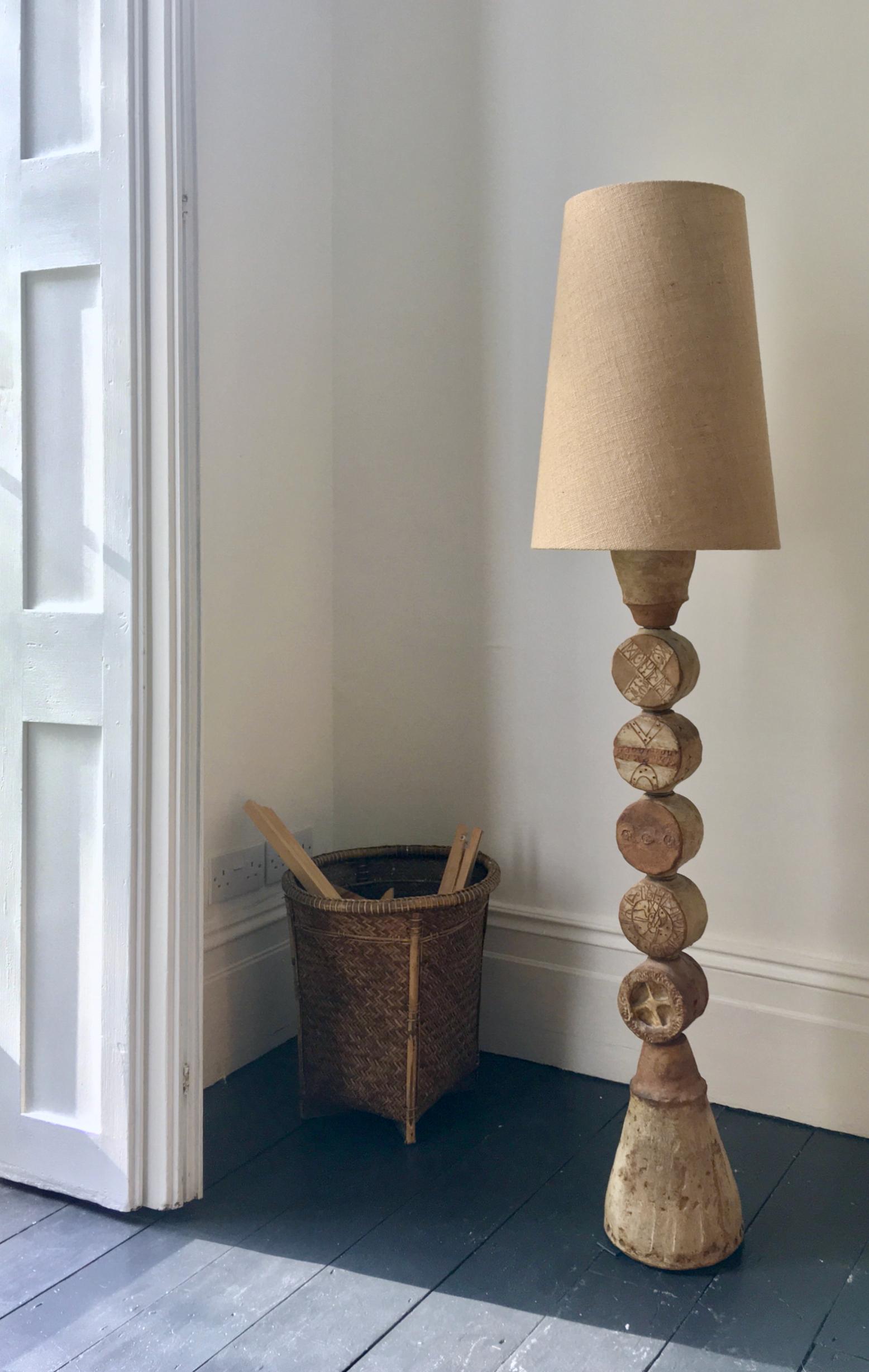 A monumental ceramic TOTEM floor lamp by Bernard Rooke, mid-20th century England.

A beautiful sculptural piece, made up of ceramic elements in natural tones of terracotta and stone. A very unusual model with a large cone-shaped base; each of the