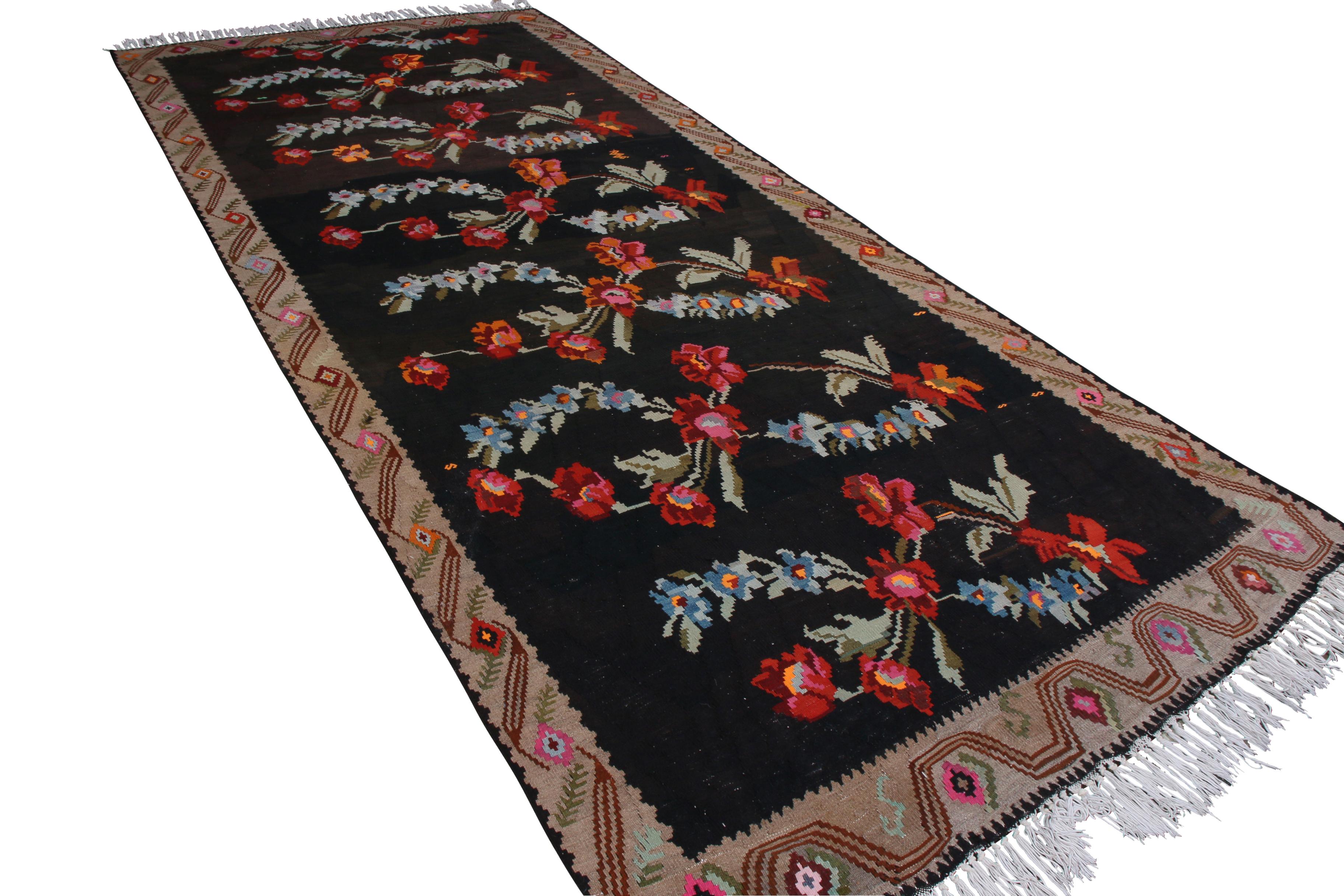 This vintage Turkish flat-weave kilim rug features a Bessarabian style, whose origins are traced to Romania and select European styles. Handmade with flat woven wool circa 1950-1960, this particular mid-century Bessarabian kilim features seven