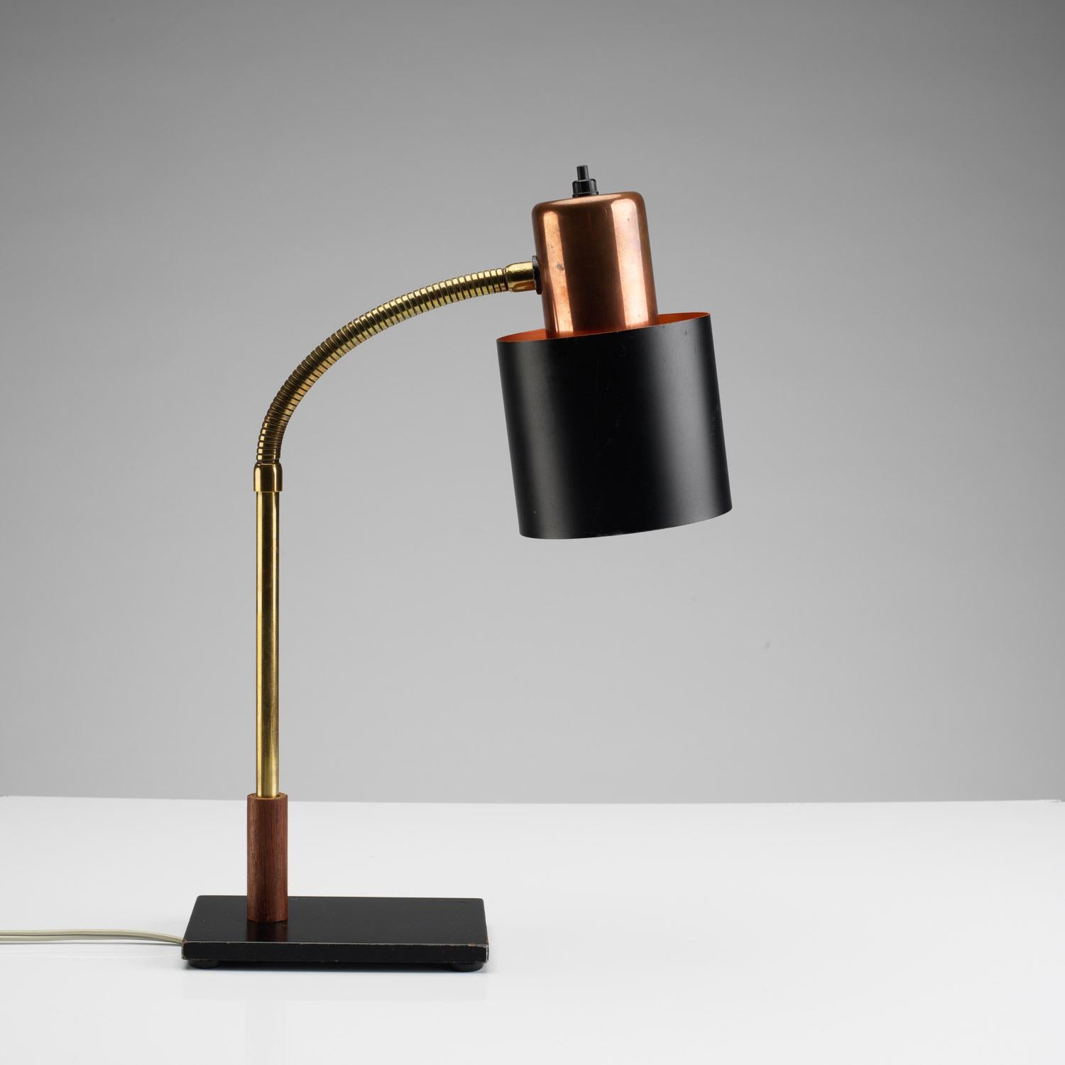 Designed by Jo Hammerborg in the late 1950s for Fog & Mørup. Flexible brass neck with teak base detail. Copper and black lacquer shade and black footplate. An iconic midcentury Danish piece.