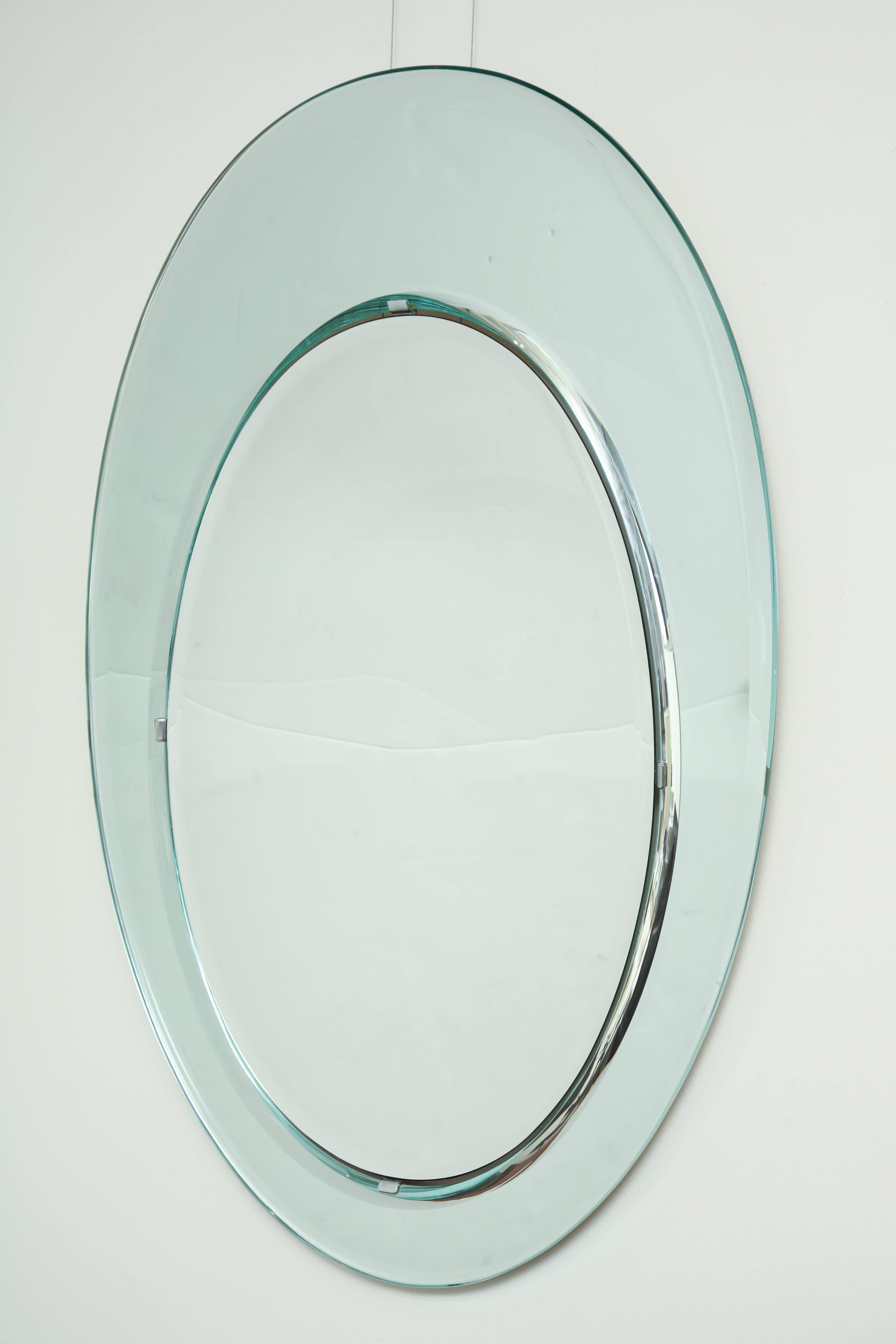 Oval bevelled mirror set in bevelled mirrored frame by Fontana Arte, Italy, circa 1970.