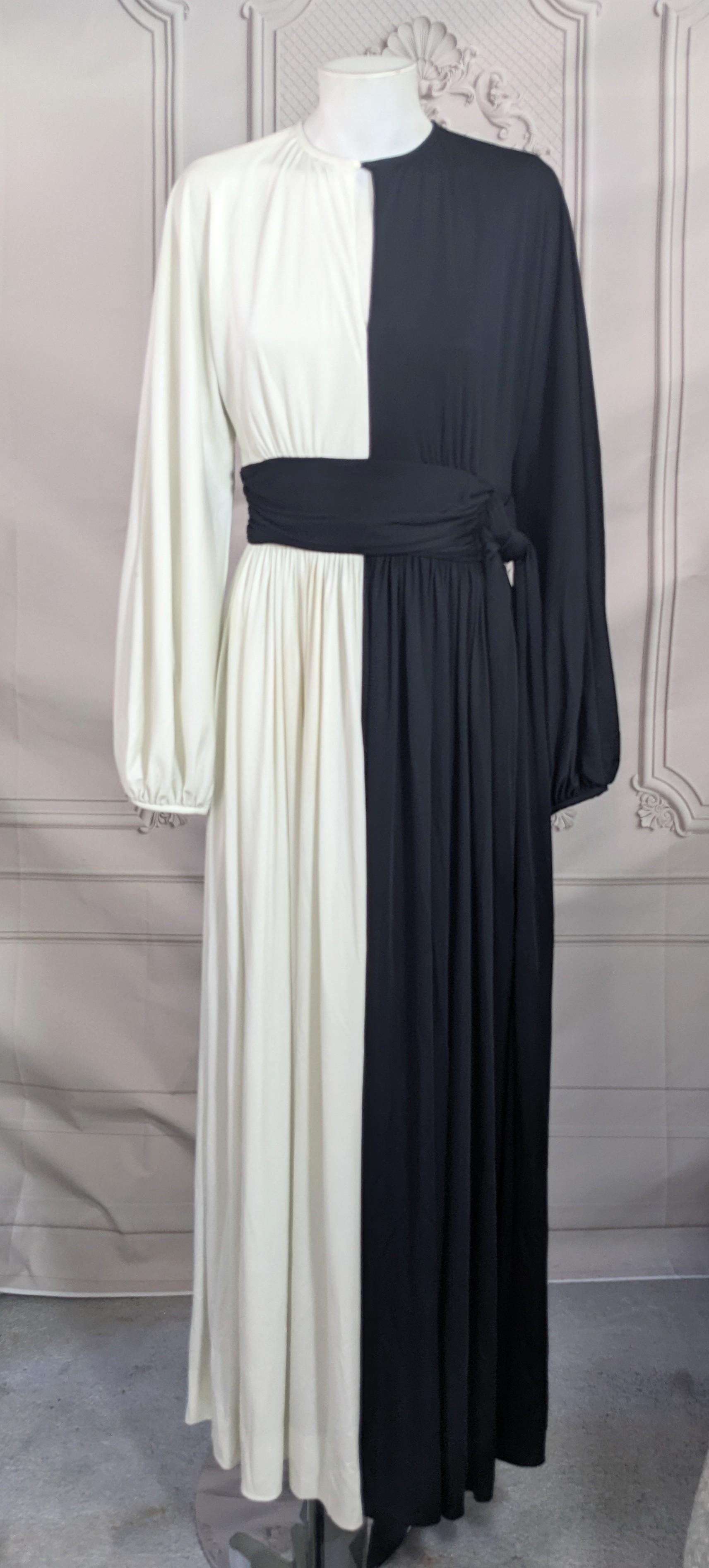 Striking Mid Century Bi Color Jersey Gown from the 1960's. Spliced right down the middle with attached draped sash which ties on the left. Full poet sleeves and front neckline slit (doesnt open). Back zip entry. Small size. Vintage 6, fits more like