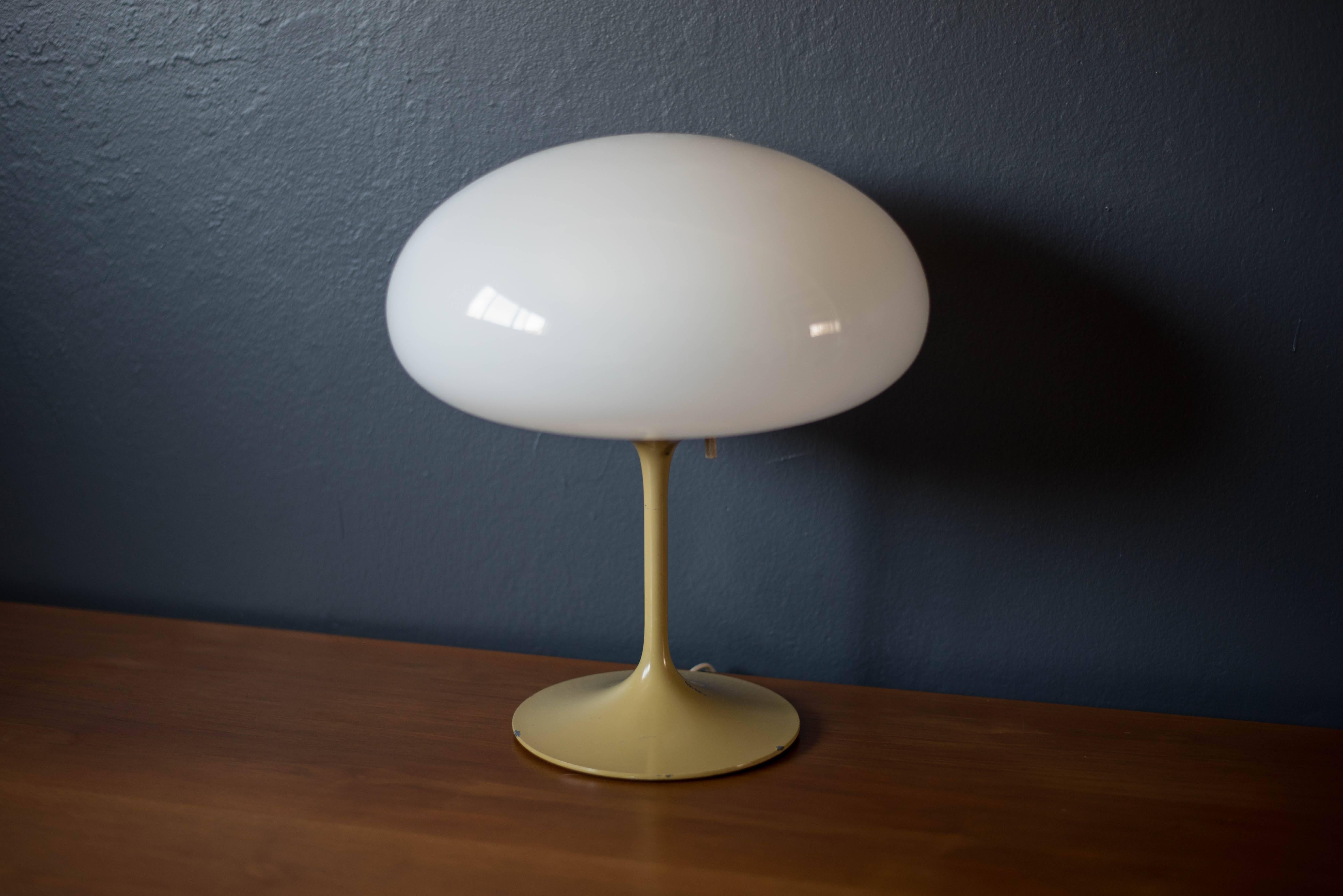 Vintage stemlite lamp by Bill Curry for Design Line. This piece features a white glass mushroom globe and a tulip base with a mustard enameled finish.