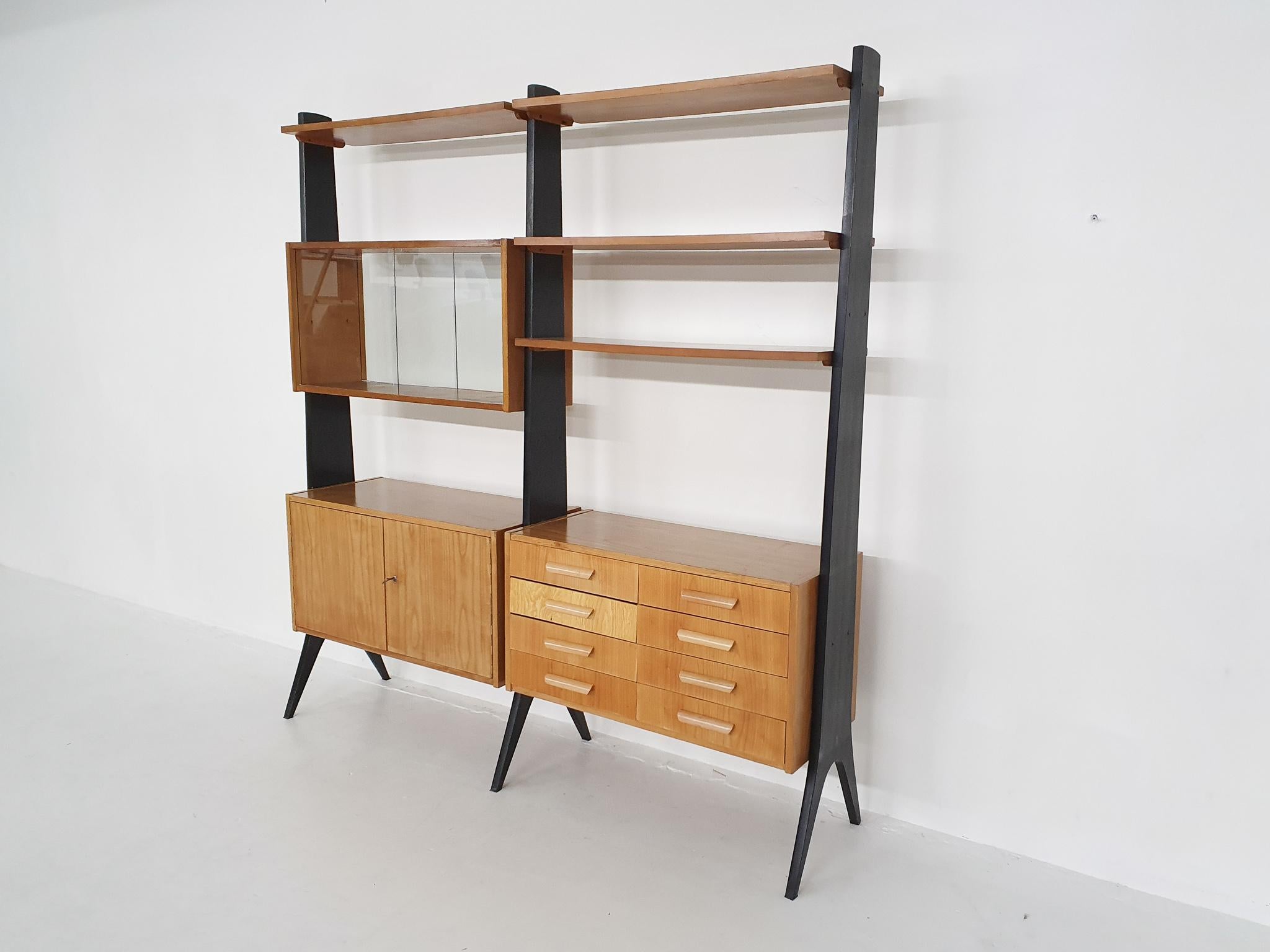 Free standing wall unit in birch veneer with black wooden risers.
the handles of the drawers are not original and one drawer is not original.

2x cabinet: 90 x 40 x 47 cm (LxWxH)
Cabinet with glass sliding doors: 90 x 30 x 47 cm (LxWxH)
4x