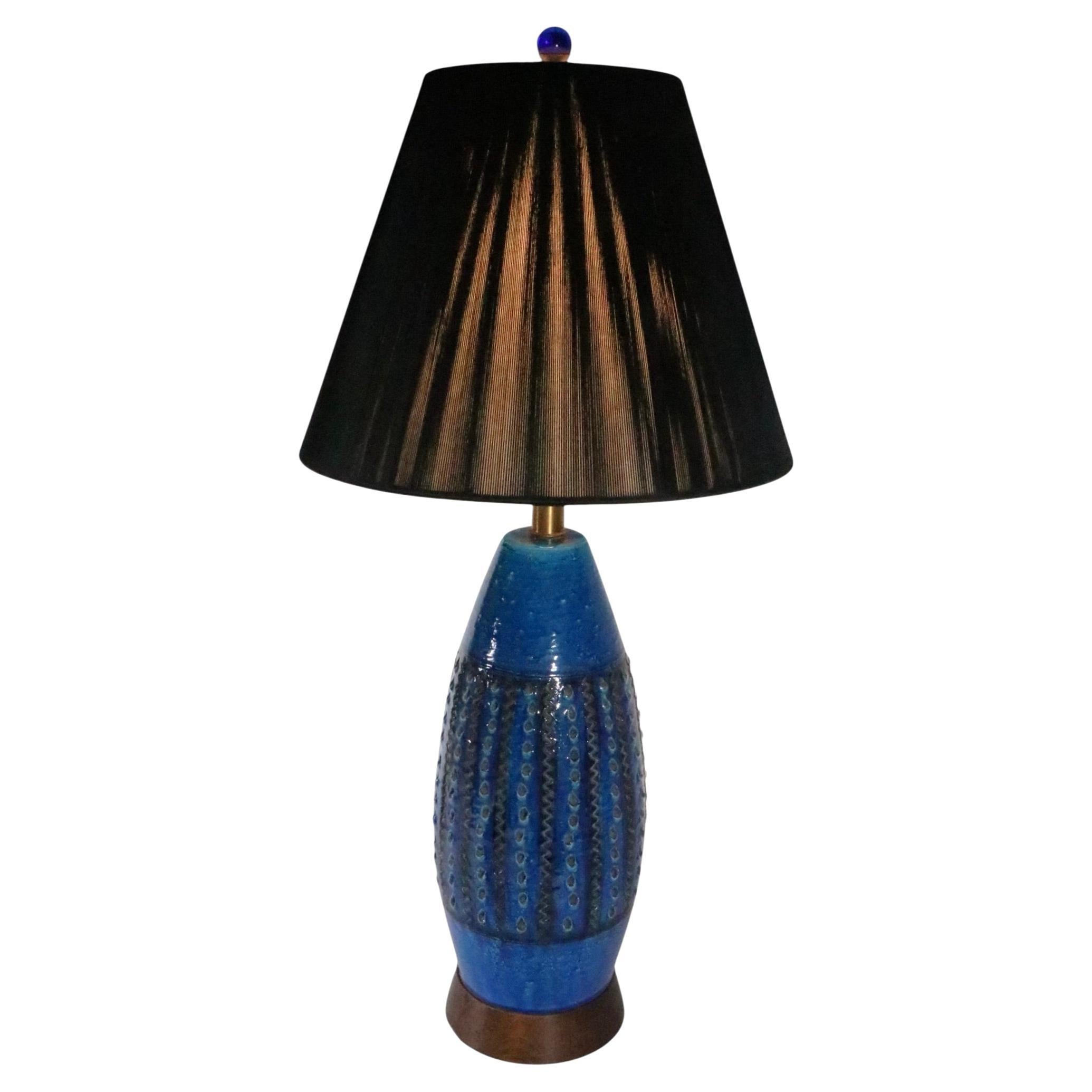 Classic Italian Mid Century ceramic pottery table lamp circa 1950/60's.
 The lamp displays the signature Mediterranean Blue glaze with an  equally signature sgraffito incised surface treatment. This example is in excellent, clean and working