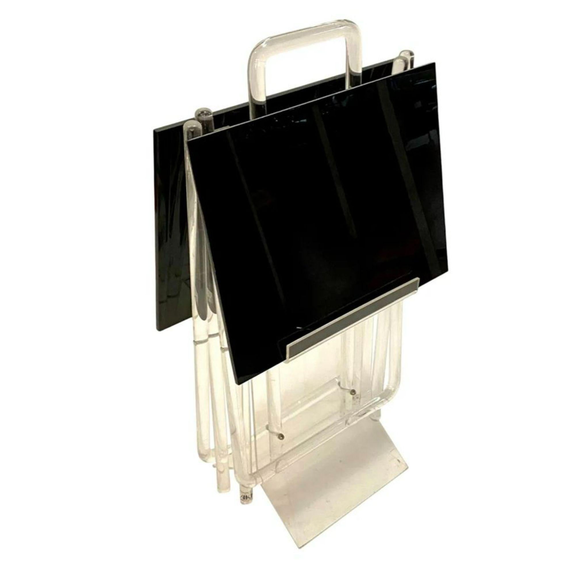 Vintage modern black Lucite tray tables on an clear acrylic stands and carrying caddy, labelled AKKO Classic Ellegance in Acrylic.

Additional Information:
Materials: Acrylic, Lucite
Color: Black
Style: Mid-Century Modern, Modern
Style After: