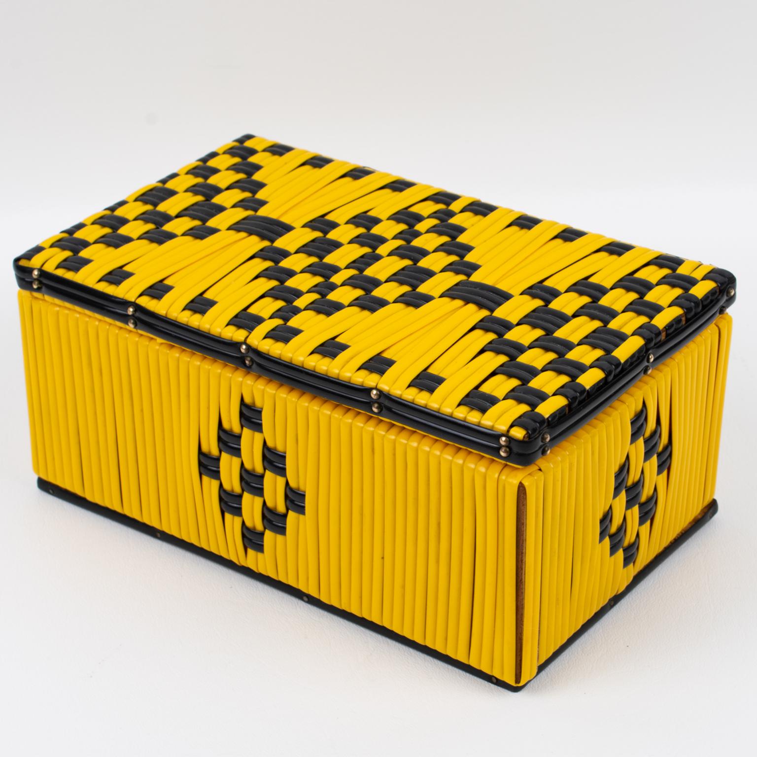 This lovely 1950s French decorative lidded box features a bright yellow vinyl plastic scooby or craft lace (in French scoubidou) with black contrast thread. The box boasts a stunning geometric design on all faces. There is no visible maker's