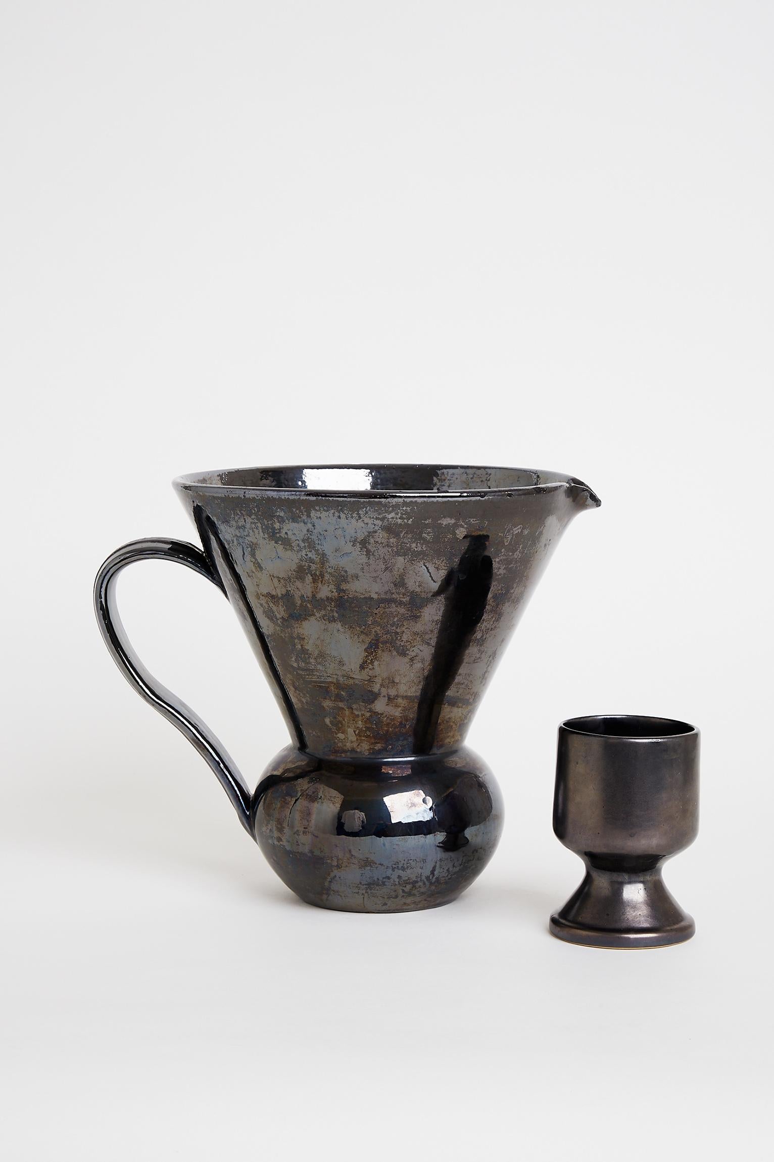 A very large black ceramic and metallic glaze jug.
France, 1950s.
