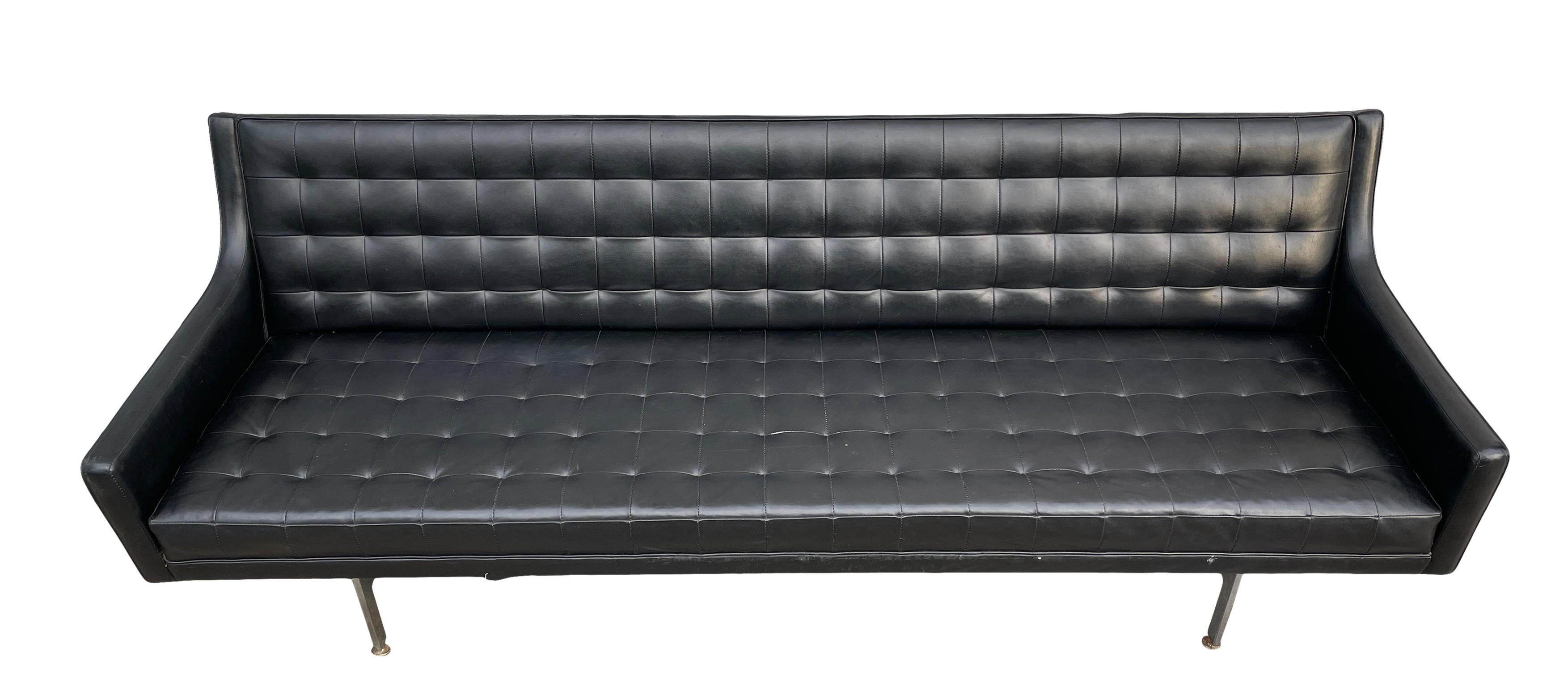 Beautiful unique Mid-Century Modern black faux leather vinyl tufted sofa with walnut wood base and soft Black Vinyl by Patrician. Very soft black Vinyl faux leather on chrome frame and simple structure. Low seating 17