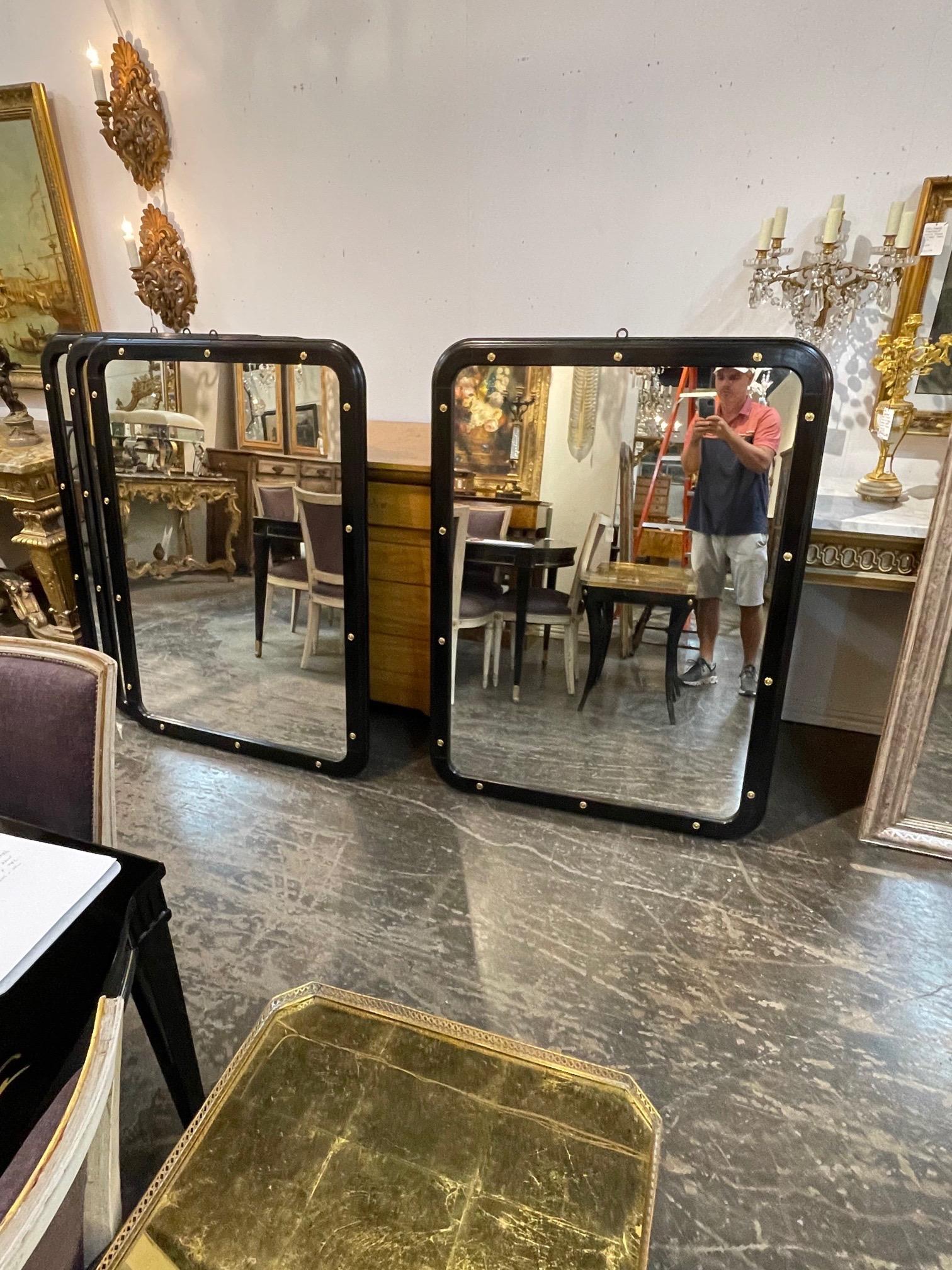Elegant Mid Century black lacquered and brass mirrors. These create a very polished look. There are 4 available. Price listed is for one. A great choice for a variety of decors!