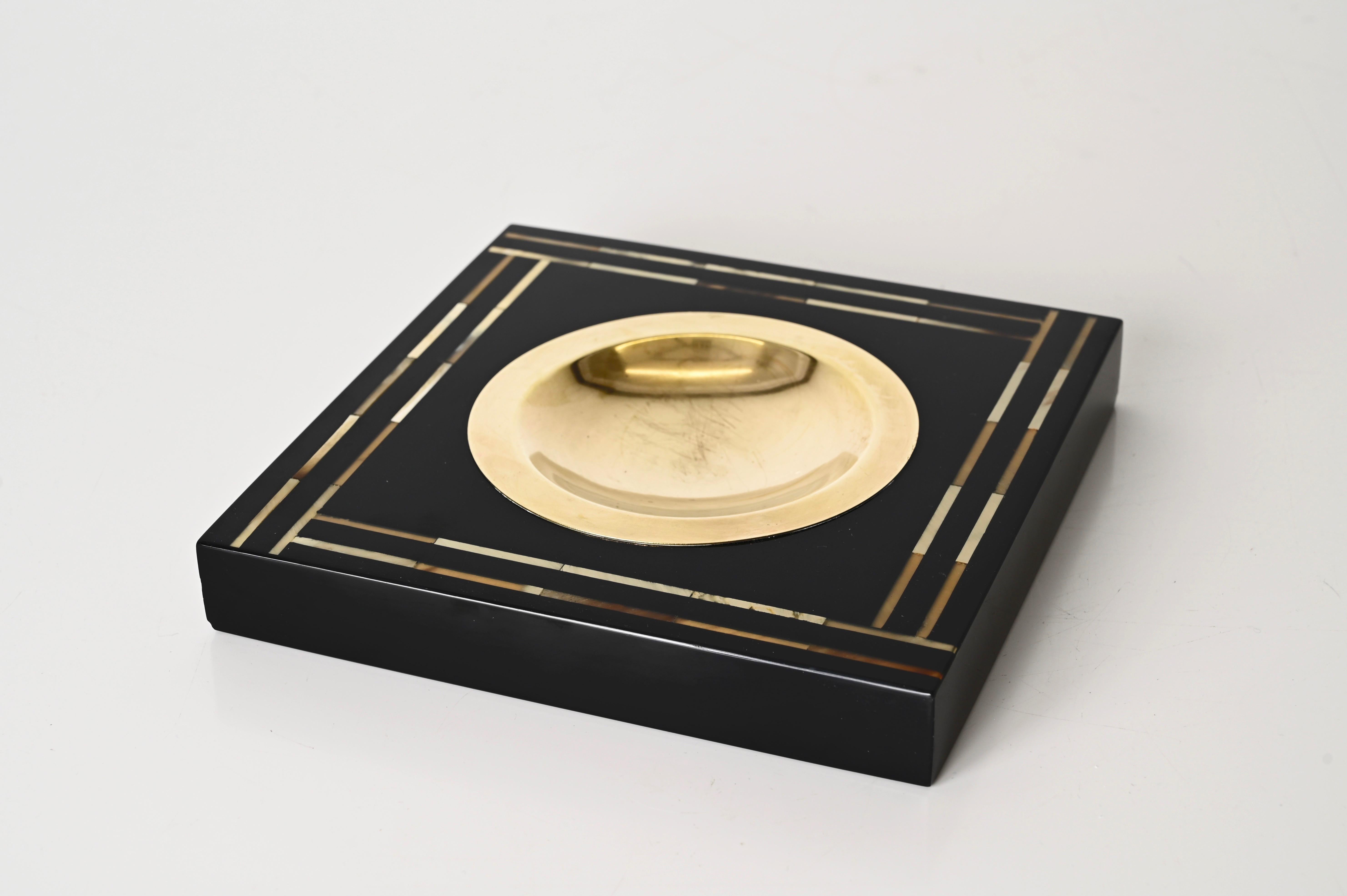 Splendid square pocket tray or ashtray made in black lacquered wood, shell and brass. This incredibly elegant object is attributed to Tommaso Barbi and was made in Italy during the 1970s clearly in the style of a Dior production.

Splendid example