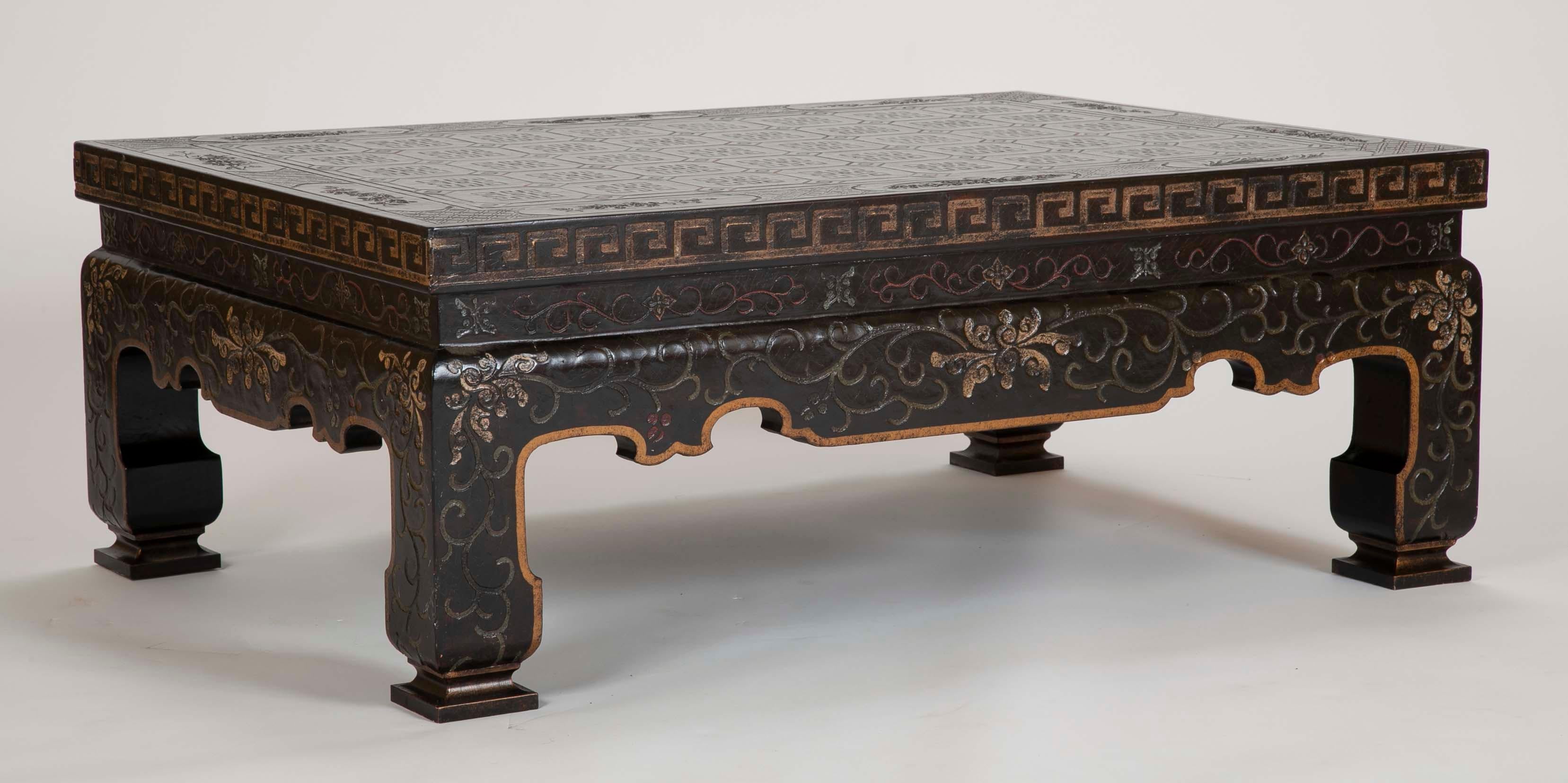 An elegant 1970s lacquered coffee or cocktail table with lovely incised black and gilt chinoiserie decoration. The solid, sculptural form of this table will make a stunning addition to any living room.