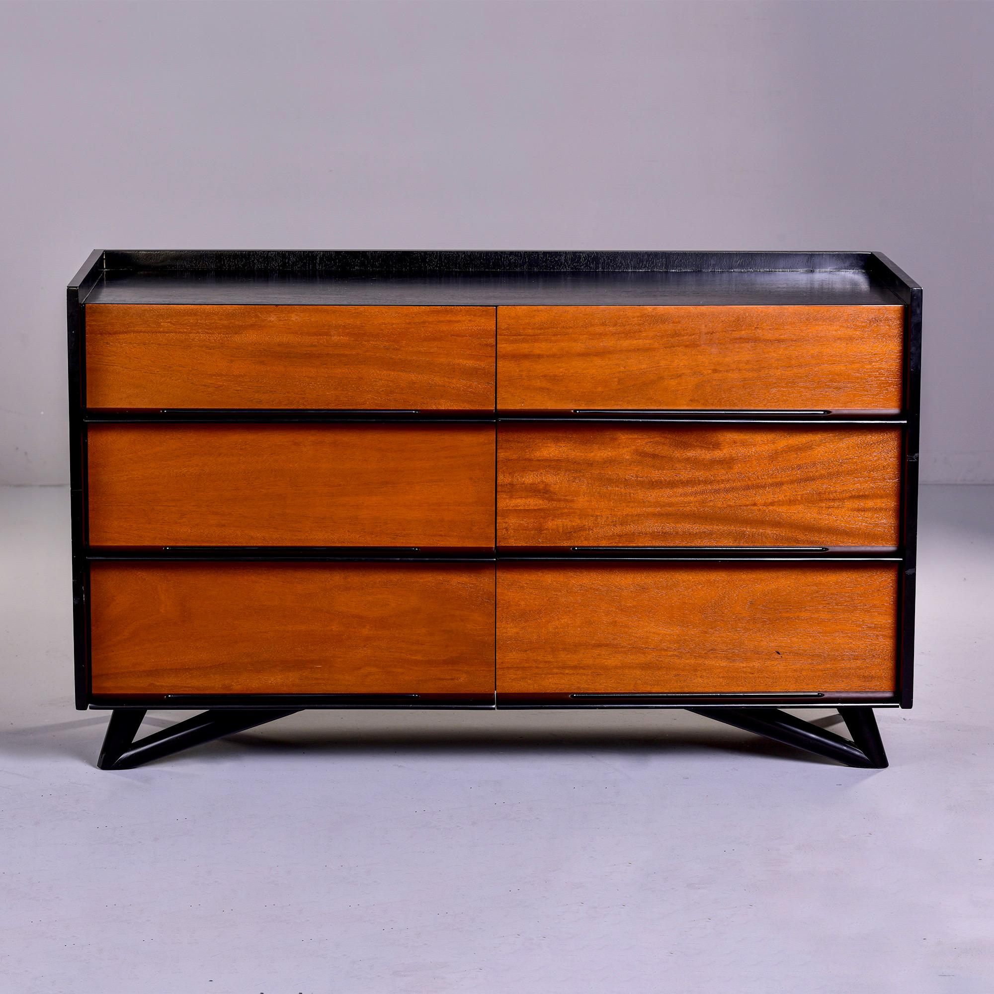 Found in US, this circa 1960s six drawer chest features a black lacquered frame, open work drawer pulls, base, legs and feet while the drawers are in a contrasting wood - probably walnut. Unknown maker - no manufacturer’s marks found but this is a