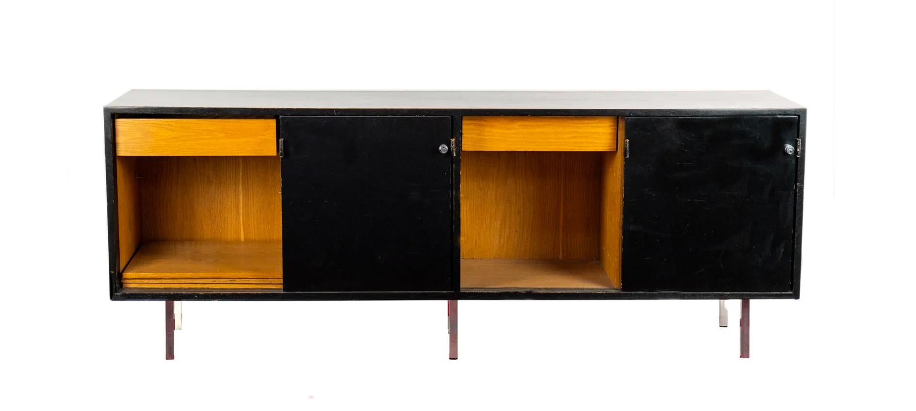 Beautiful practical credenza for living or office space. Sliding doors with leather pulls reveal two file cabinets, drawers and adjustable shelves. Perfect for your storage needs. Cabinet is made of Oak with a black lacquer finish that sits on 6