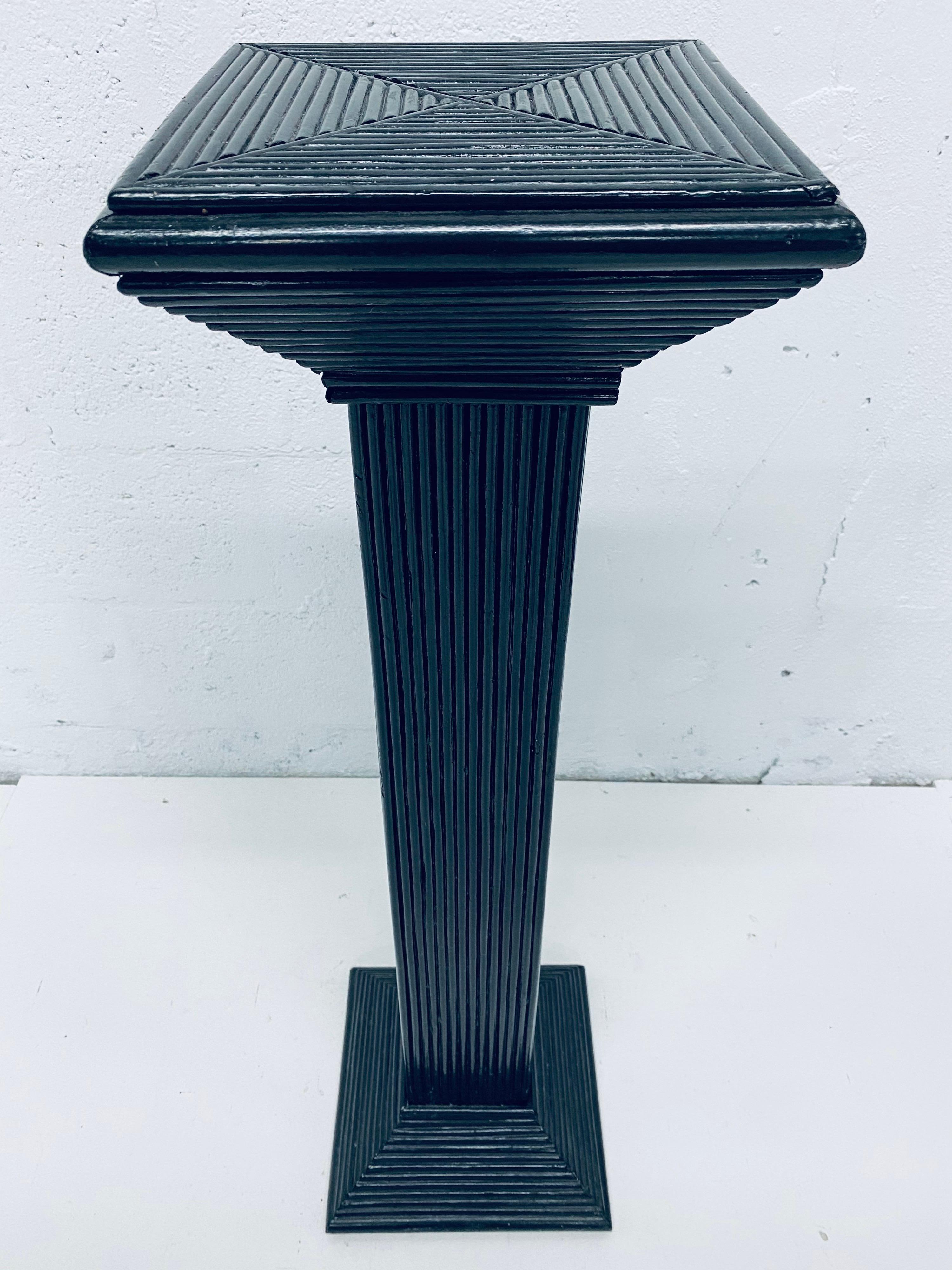 Black lacquered pencil reed rattan pedestal column table from the 1960s. 

Surface dimensions: W 9-1/2