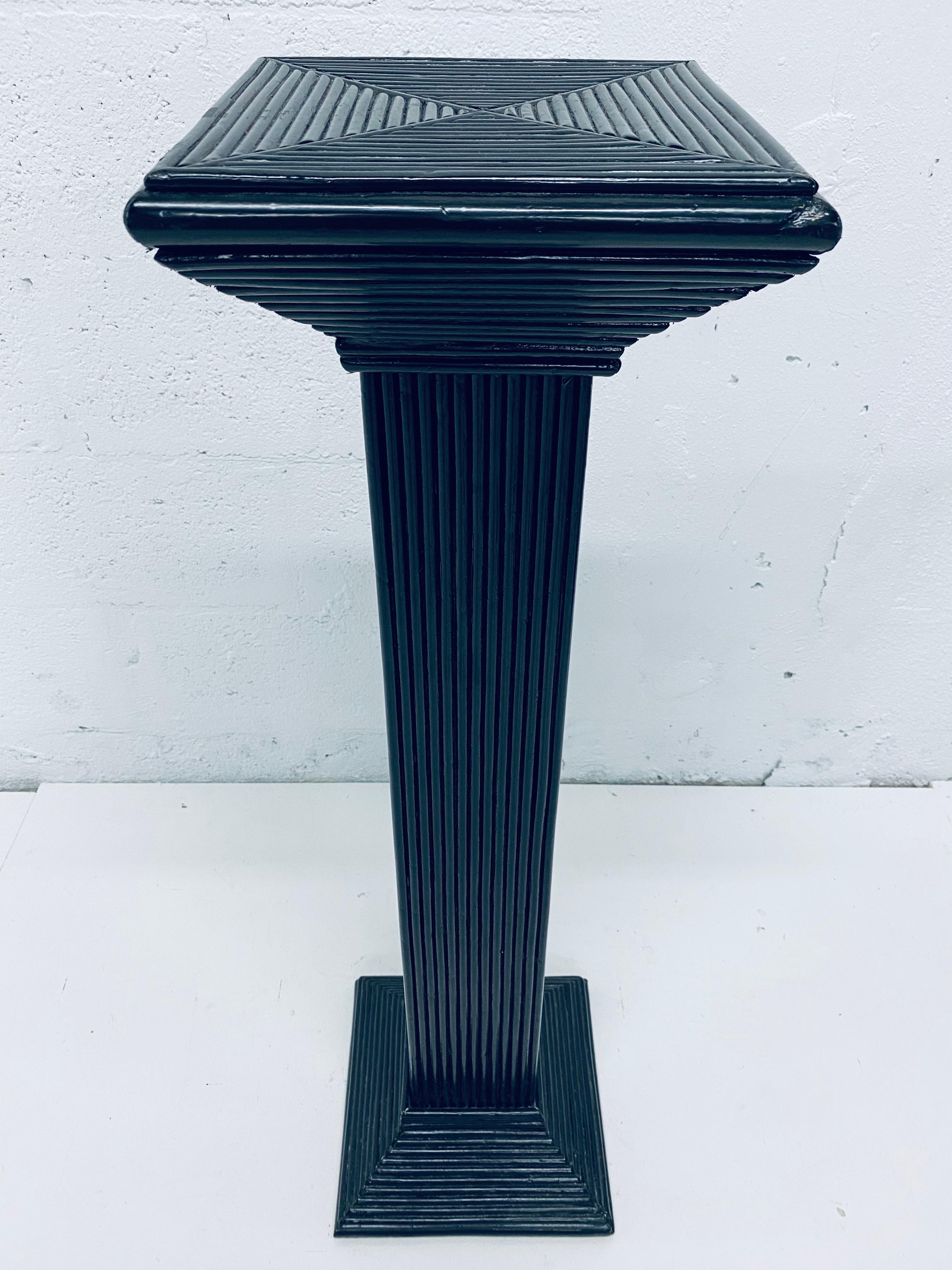 Black lacquered pencil reed rattan pedestal column table from the 1960s. 

Surface dimensions: W 9-1/2