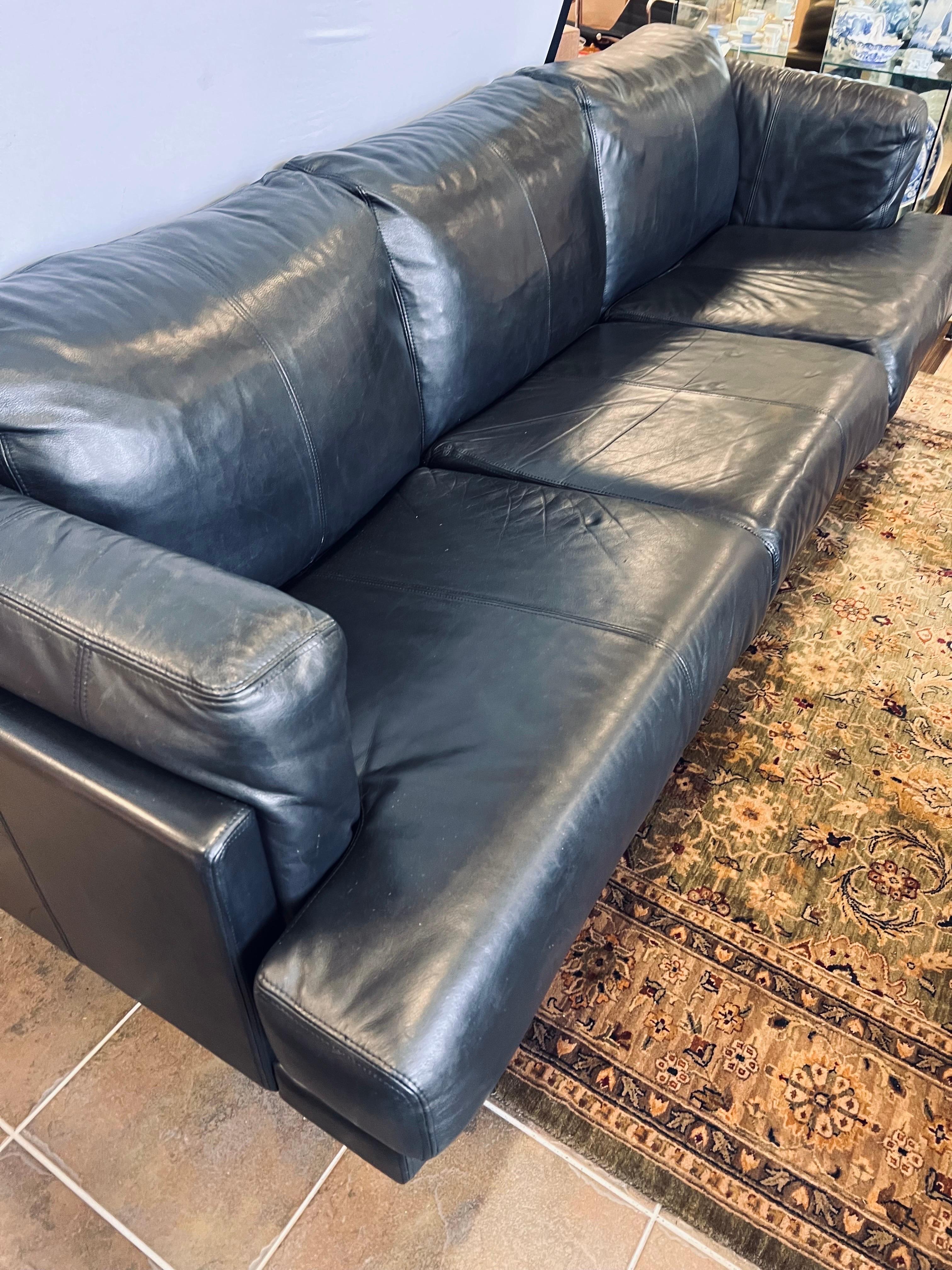 Handsome midcentury vintage black leather sofa on chrome legs in great condition. This sofa has loose cushions and Minimalist chrome metal legs. Upholstery is a buttery soft leather with no fading. By Directional.