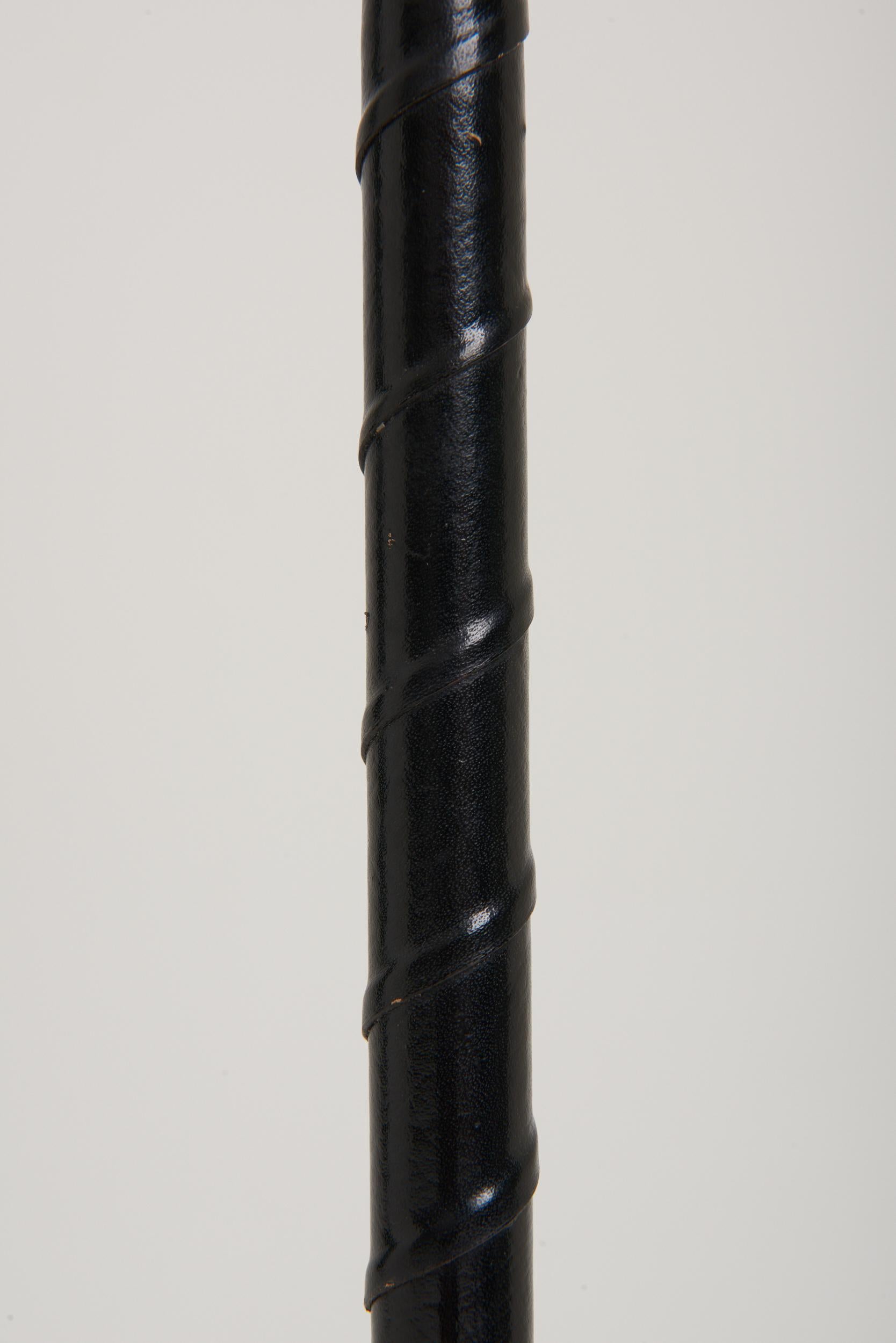 A twisted black leather and nickel floor lamp.
Sweden, third quarter of the 20th Century.
Measures: With the shade: 155 cm high by 45 cm diameter.
Lamp base only: 130 cm high by 25 cm diameter.
