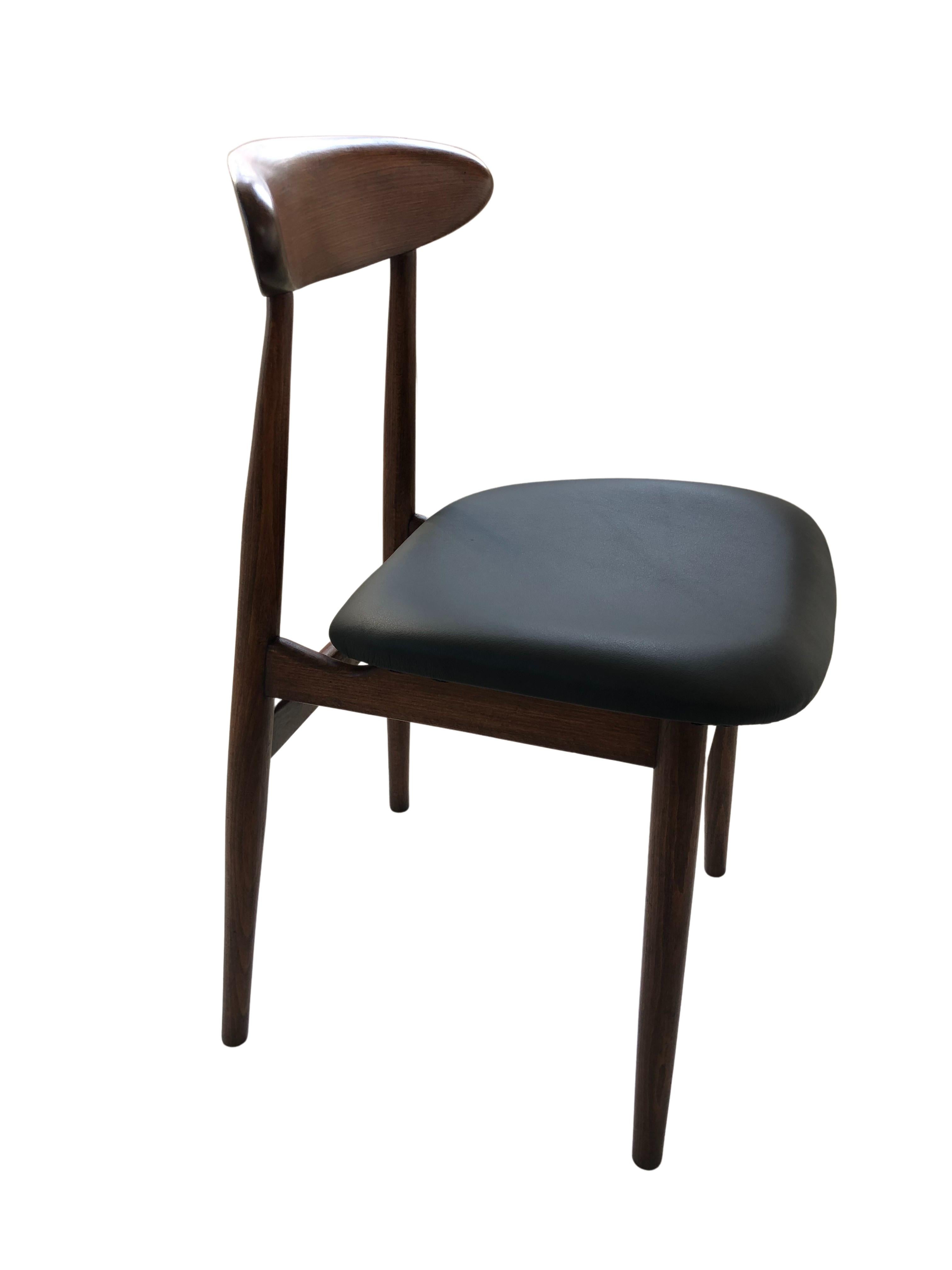 Set of two chairs model 5908, designed by Rajmund Teofil Halas, one of the most recognizable projects of Polish design in the 60s. The chairs have a simple, modernist silhouette. The structure is made of solid beechwood in a warm walnut color,