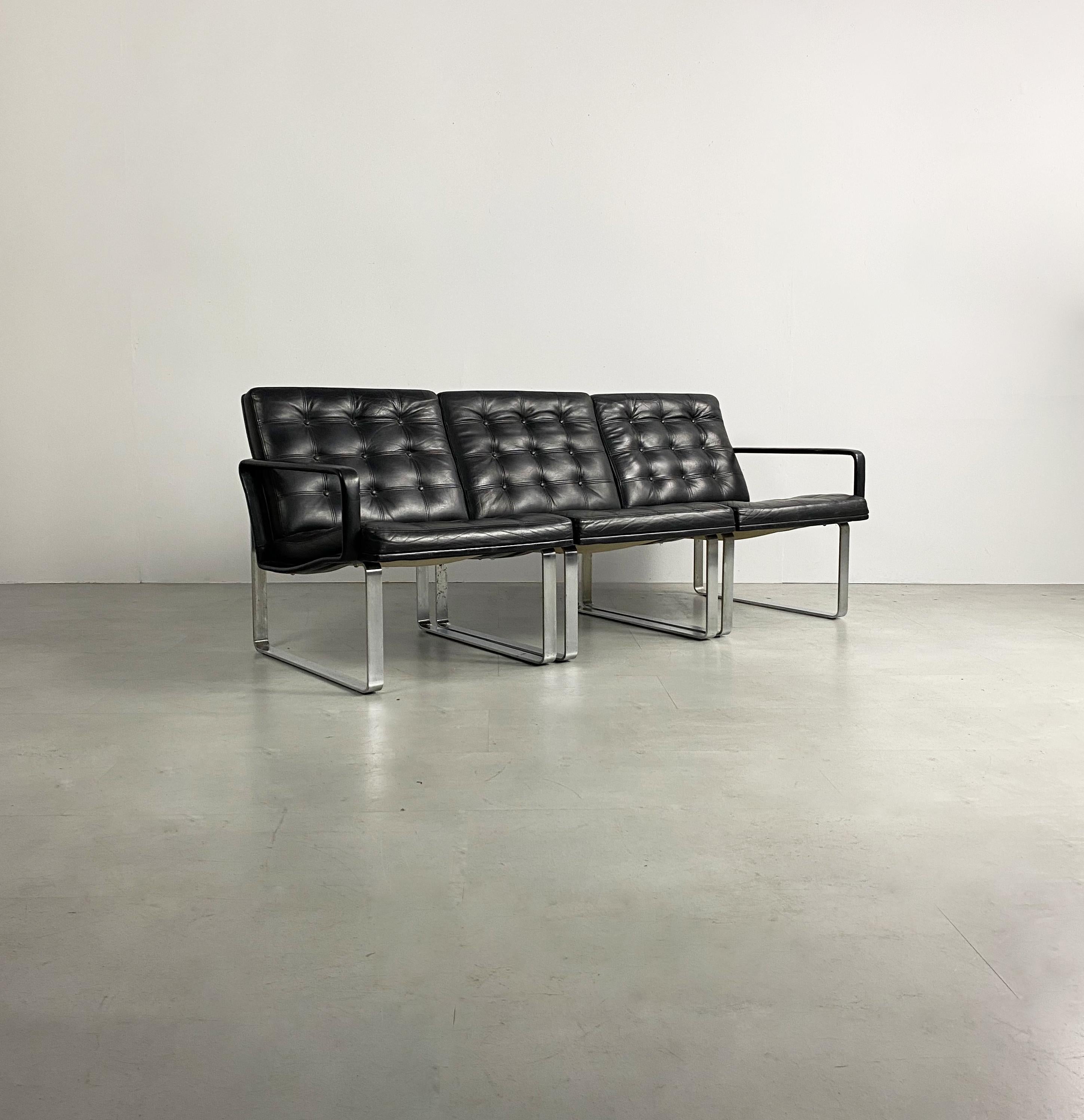 Exquisite modular 3 piece sofa designed by Ole Gjerløv-Knudsen & Torben Lind and produced by Danish manufacturer Cado, circa 1960. Upholstered in black leather with buttoned patchwork detailing, supported by a sculptural steel frame. This sofa can