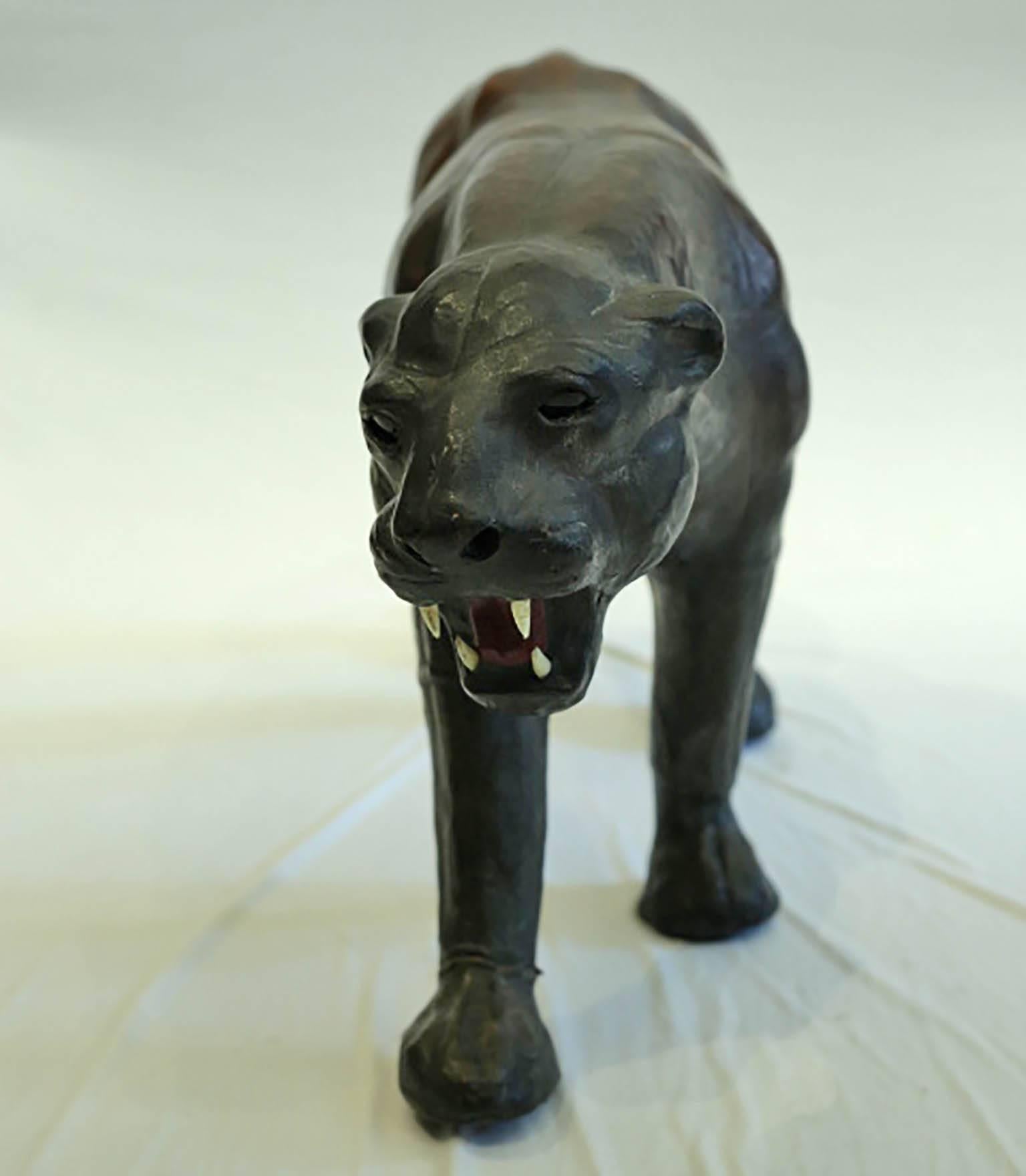 Large all leather black panther with white fangs and red tongue, circa 1970s. Good condition. It appears that the whiskers are missing. No cracks in the body or on the tail.
