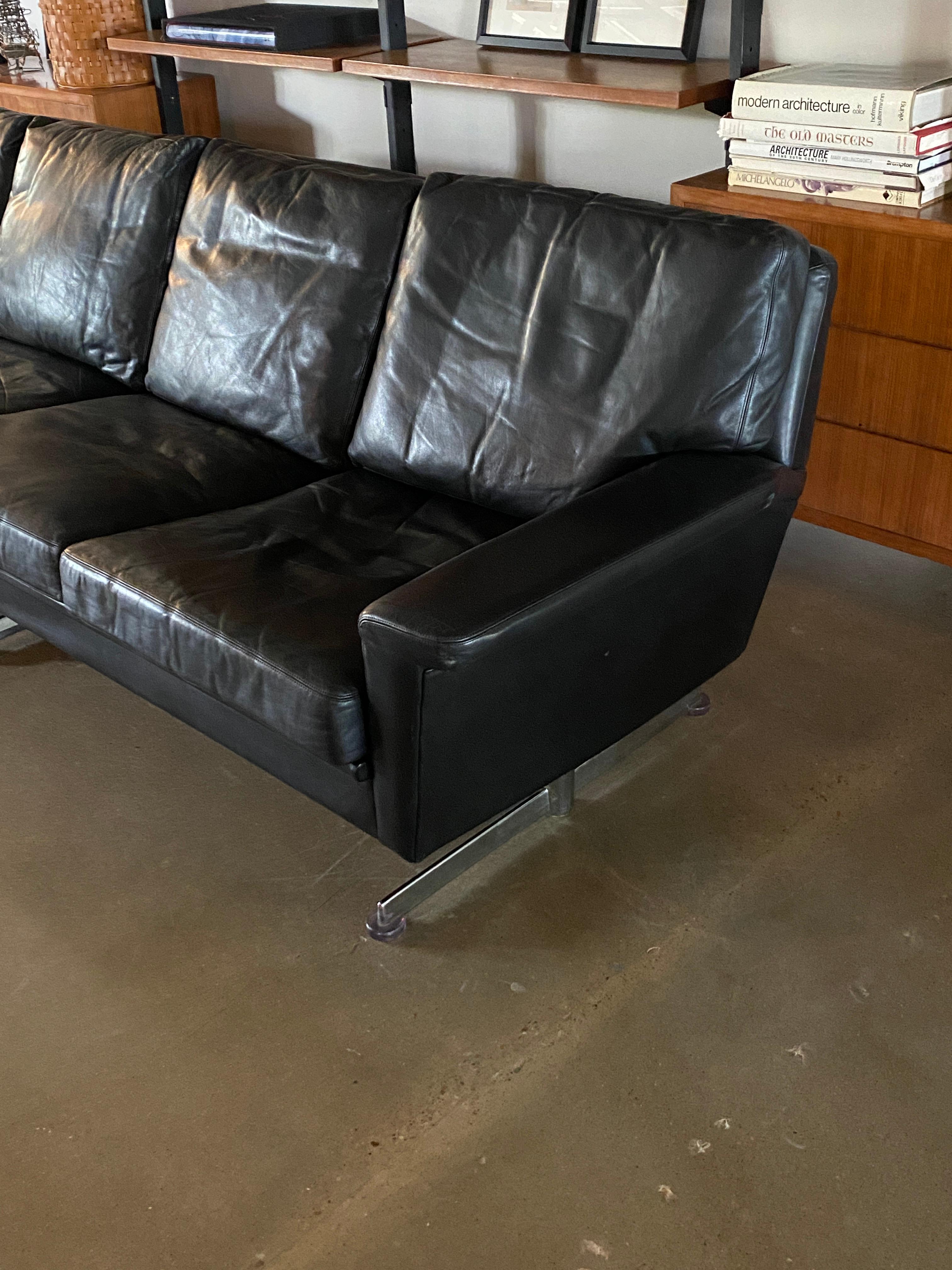 modern black leather sofa with chrome legs