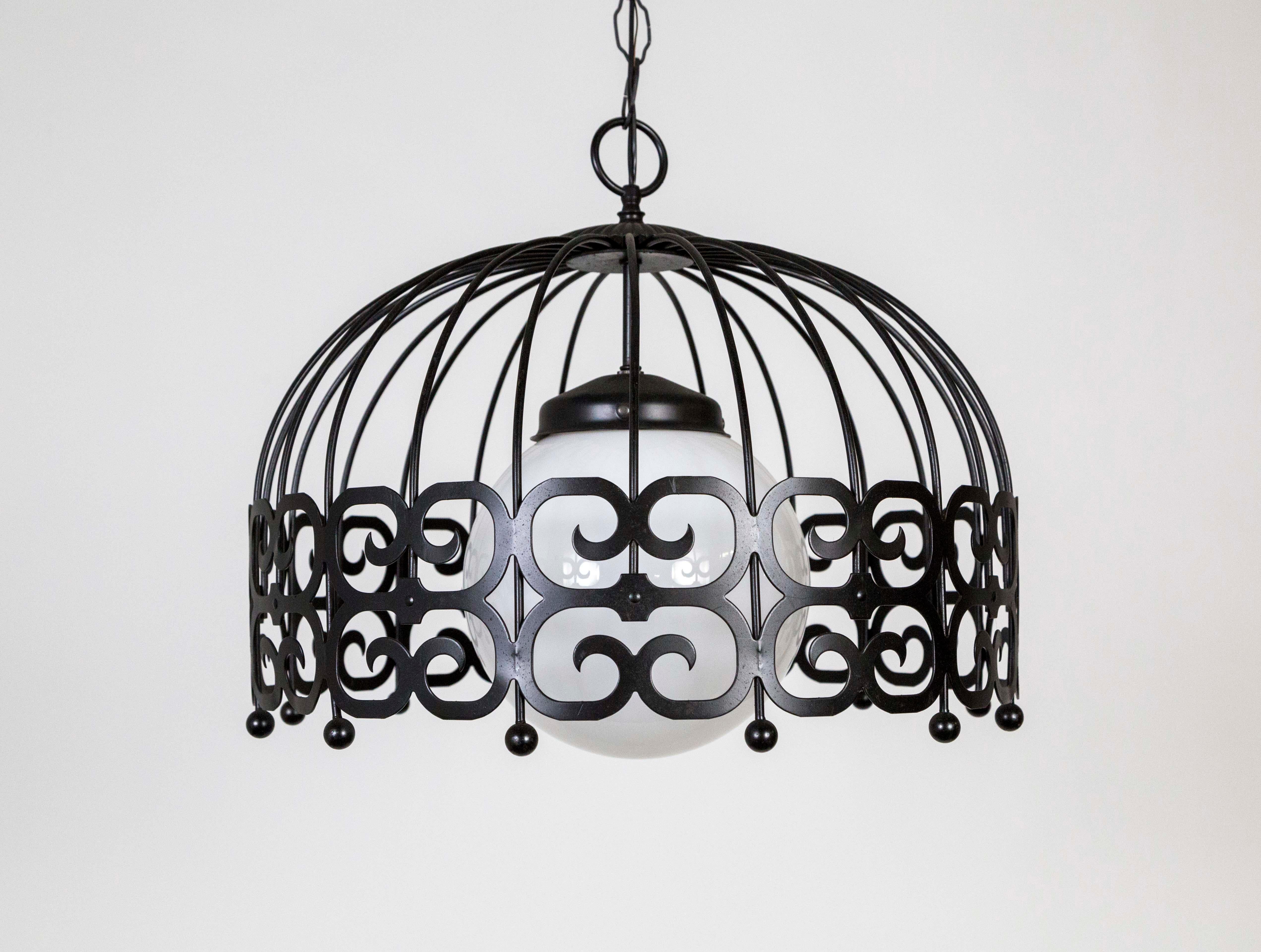 A pendant light consisting of a dome shape wire armature, with iconic Arthur Umanoff scrolls and ball details, surrounding a suspended, white glass ball shade. Black satin finished metal, newly wired with a long chain and matching canopy. Measures: