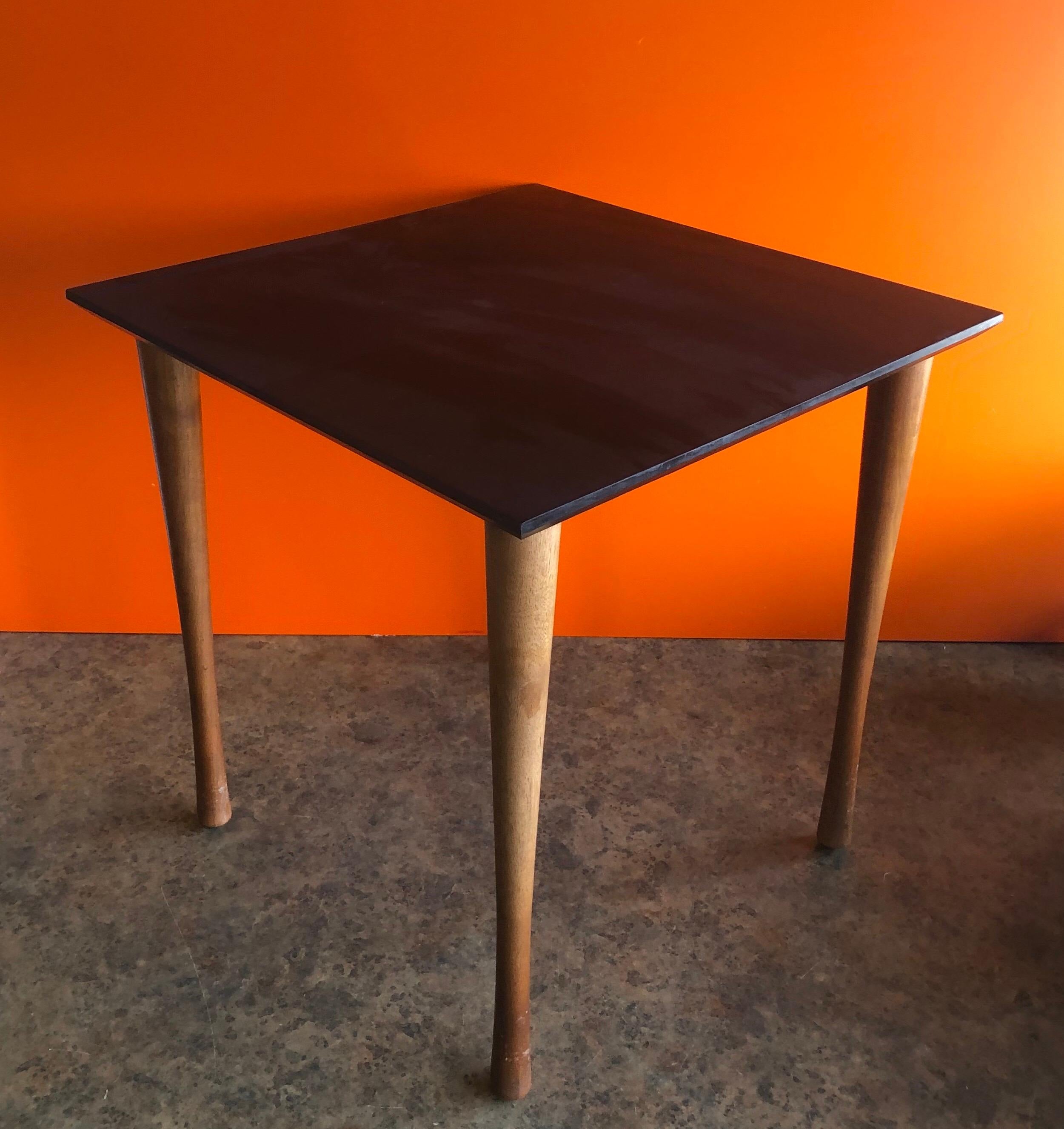 Midcentury quartered black slate side table with solid walnut legs by Harpswell House, circa 1970s. The piece is in very good condition and measures: 17.875 square x 18.125