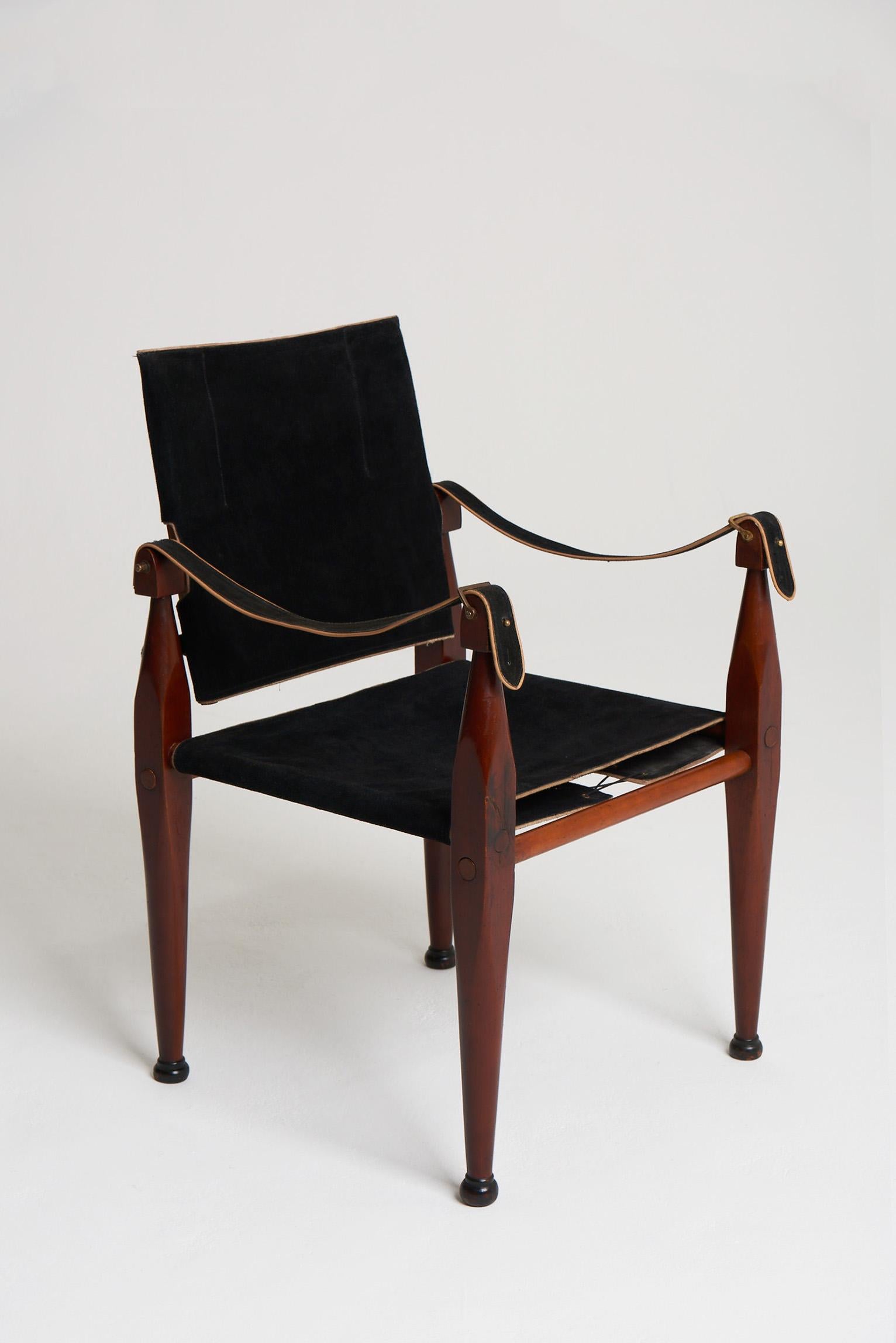 A Mid-Century teak and black suede safari chair.
Northern Europe, Circa 1950.