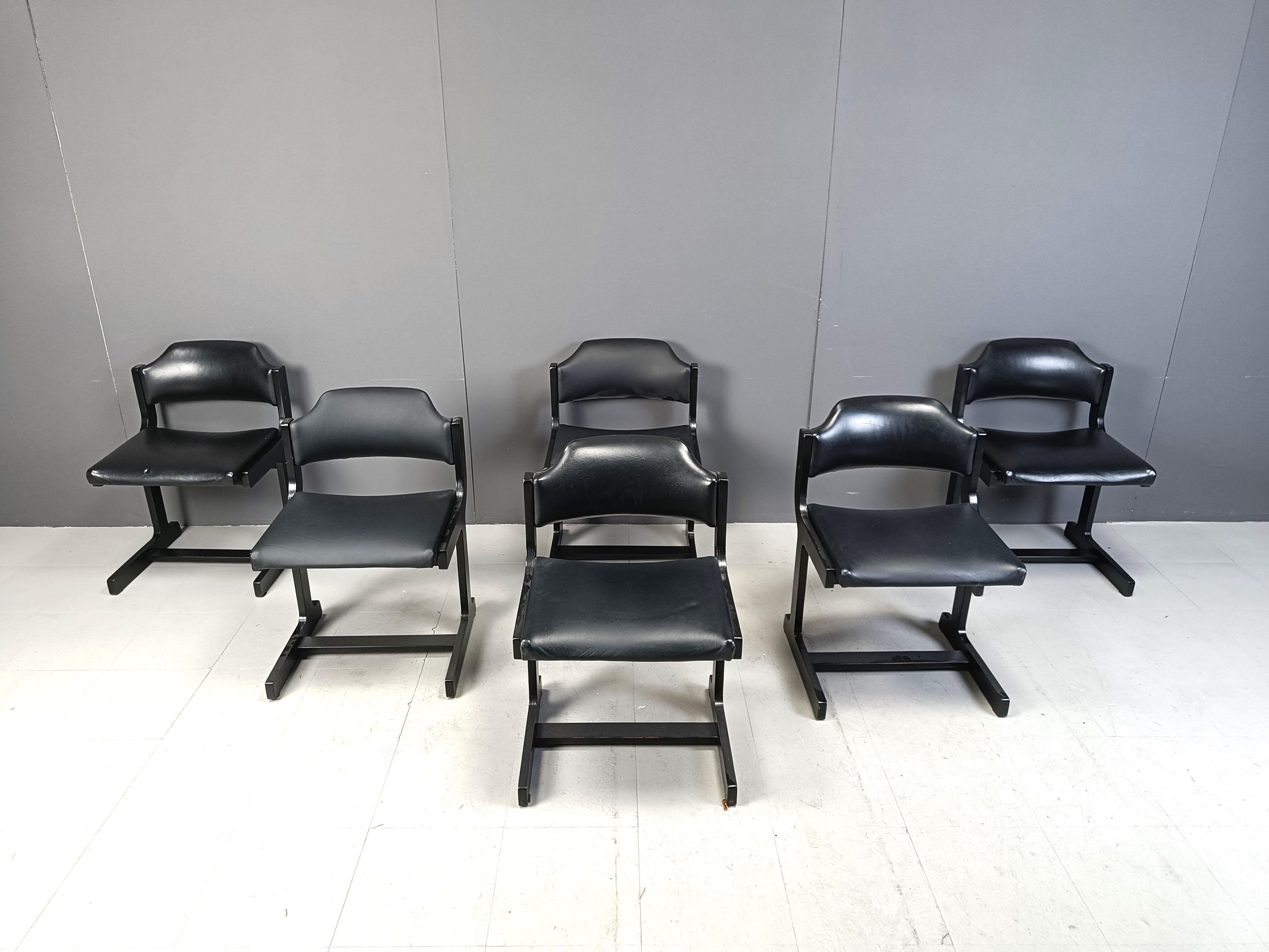 Vintage ebonized wooden space age design dining chairs with black leatherette upholstery.

Cool timeless cantilever design.

1970s - Belgium

Very good condition

Dimensions
Height: 74cm
Width: 52cm
Depth: 45cm
Seat height: 45cm

Ref.: