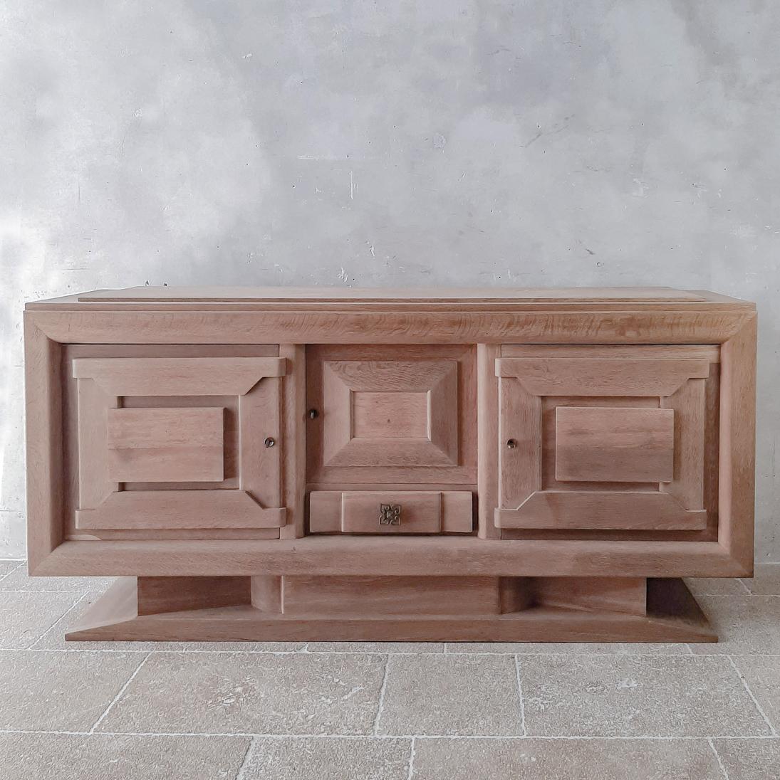 Mid-century design credenza by Charles Dudouyt in bleached oak, 1940s-50s. Beautiful sideboard in pre-Brutalist Art Deco style decorated with typical geometric shapes of Dudouyt. The base gives this sideboard an extra sturdy