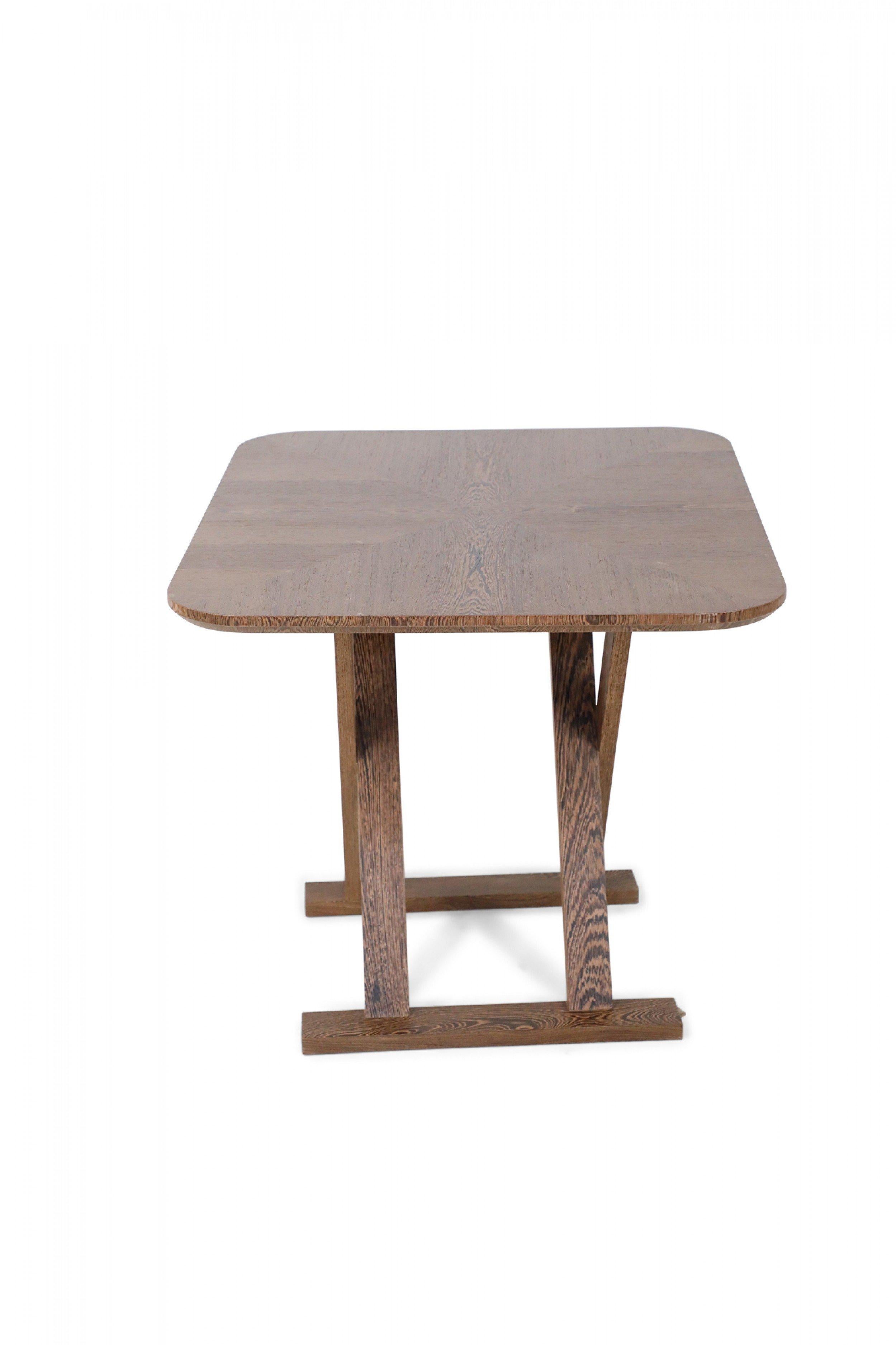 Mid-century wenge wood tea table with rectangular top and rounded corners above an x-shaped base.
      