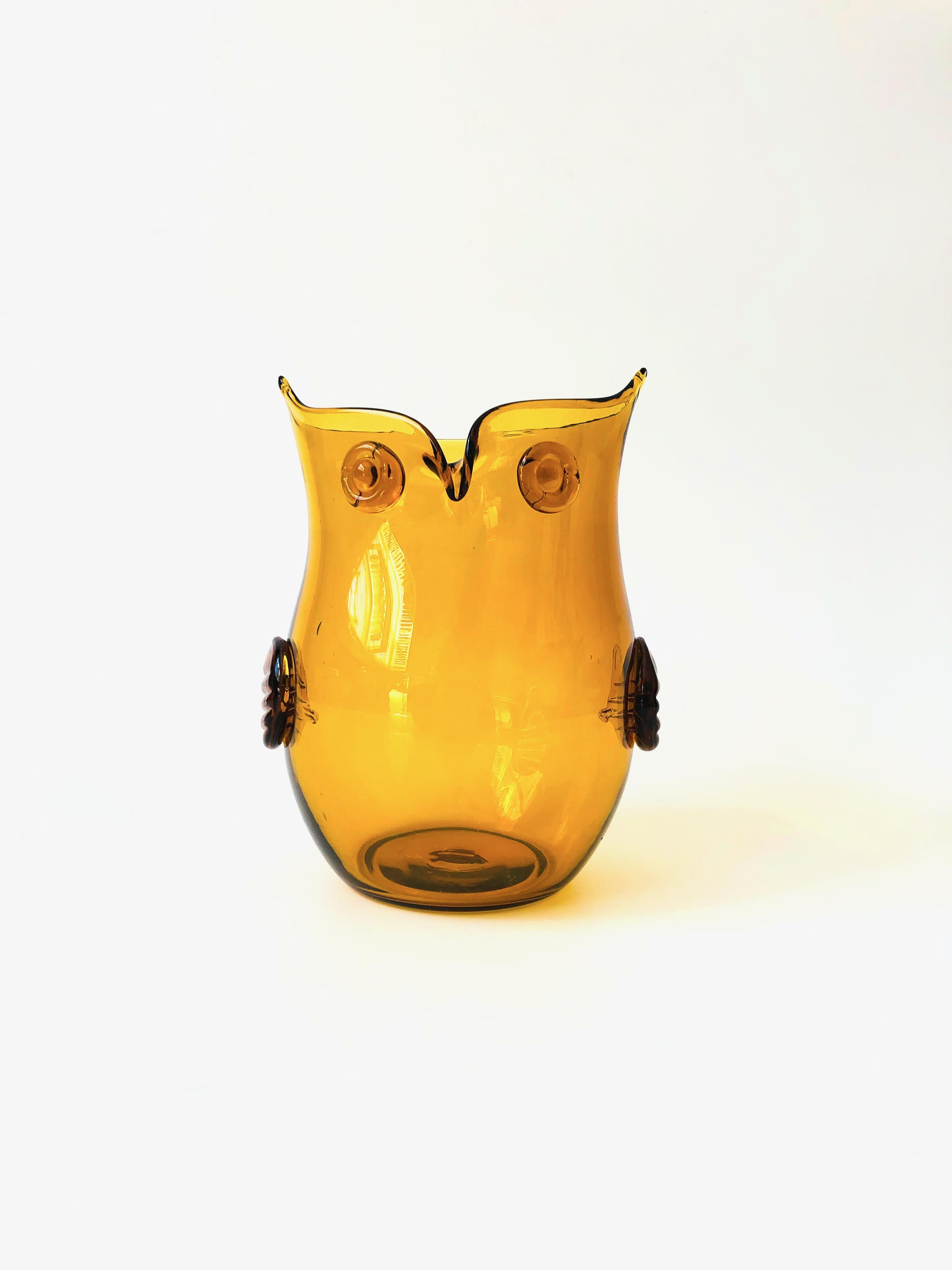A wonderful mid century glass vase in the shape of an owl. Made by Blenko. Beautiful amber color to the glass.
 