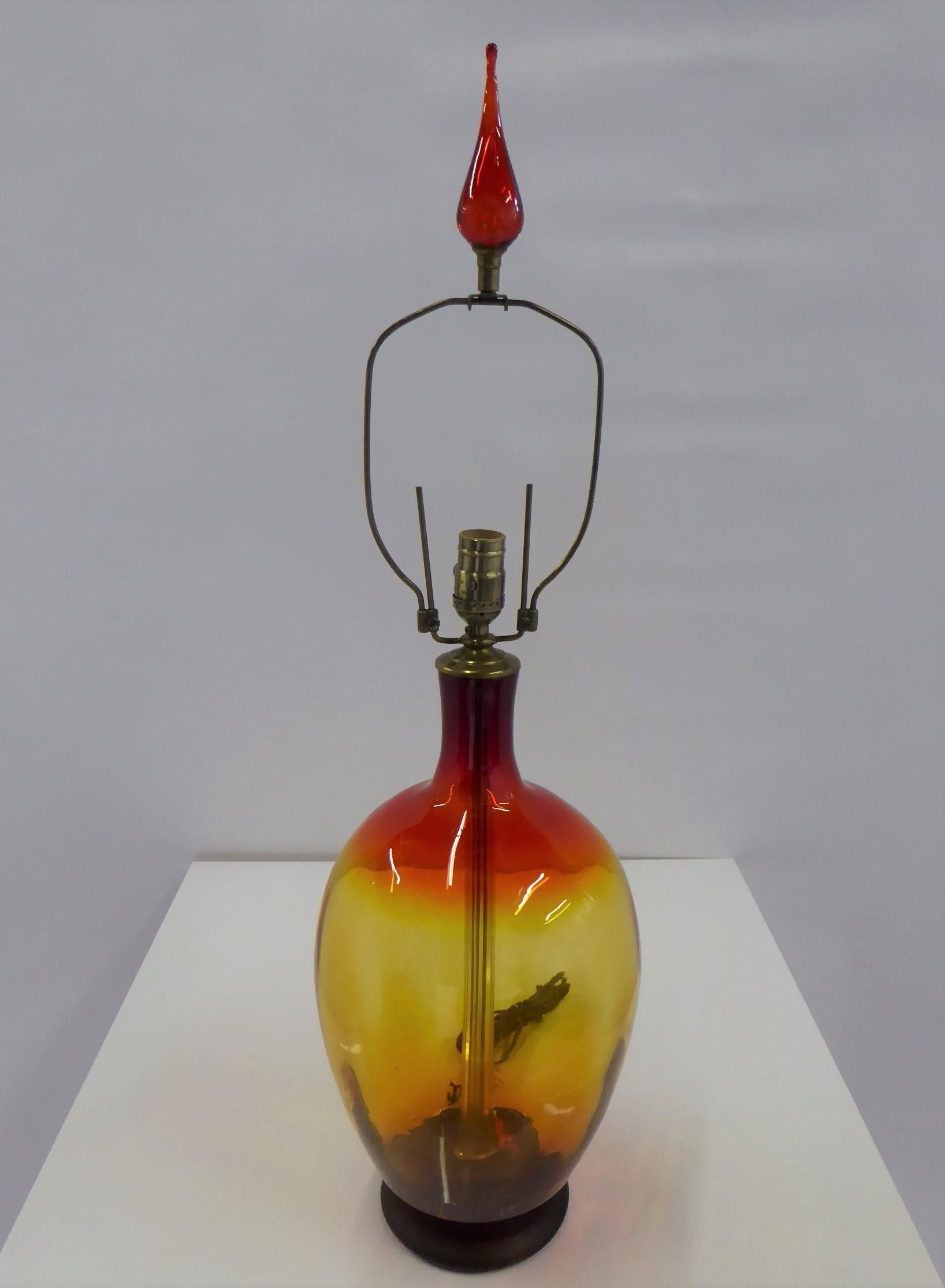 REDUCED FROM $1200....Mid-Century Modern Amberina colored glass table lamp designed by Wayne Husted in 1962 for Blenko Glass Company of West Virginia. In a dramatic large bulbous shape and in a color, called Tangerine by Blenko, which is red melding
