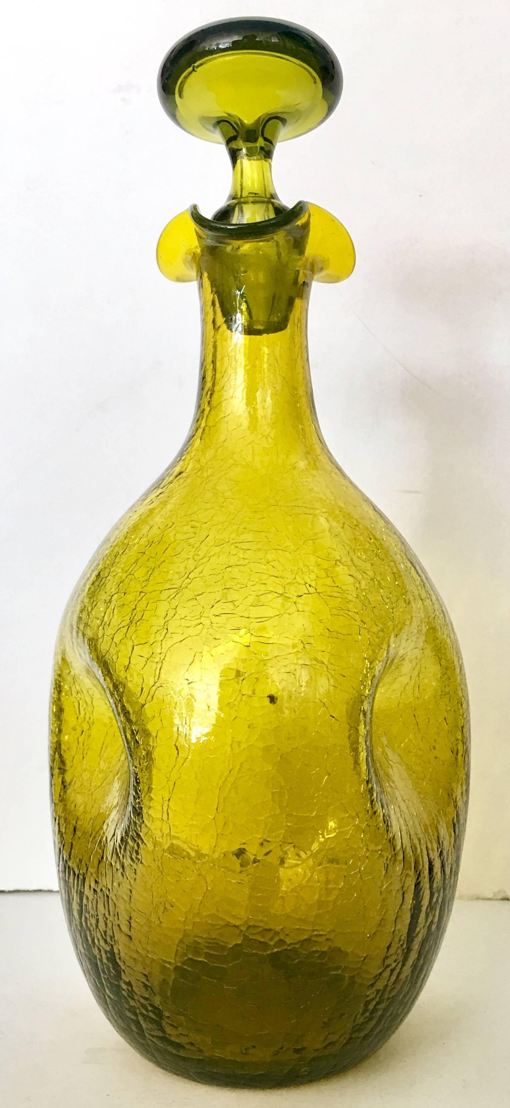 Mid-Century Modern Winslow Anderson for Blenko Glass, avocado green pinched crackle glass decanter. Features a ruffled neck with stopper,, crackled and pinched body detail, designed by Blenko designer Winslow Anderson -model #49. 
Winslow Anderson,